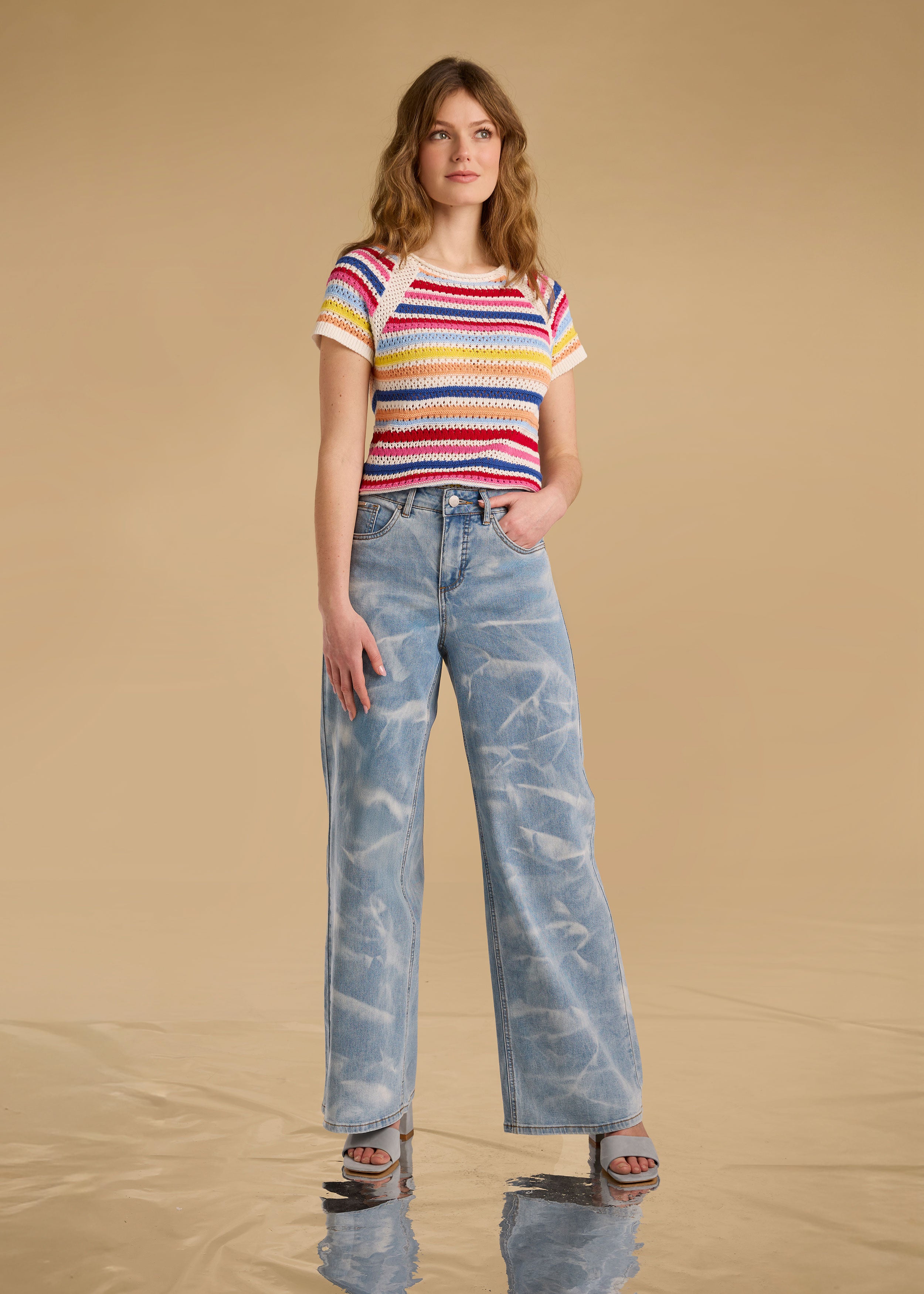 Model wearing multi-color stripe sweater with wide-leg jeans front view by French Dressing Jeans (FDJ)