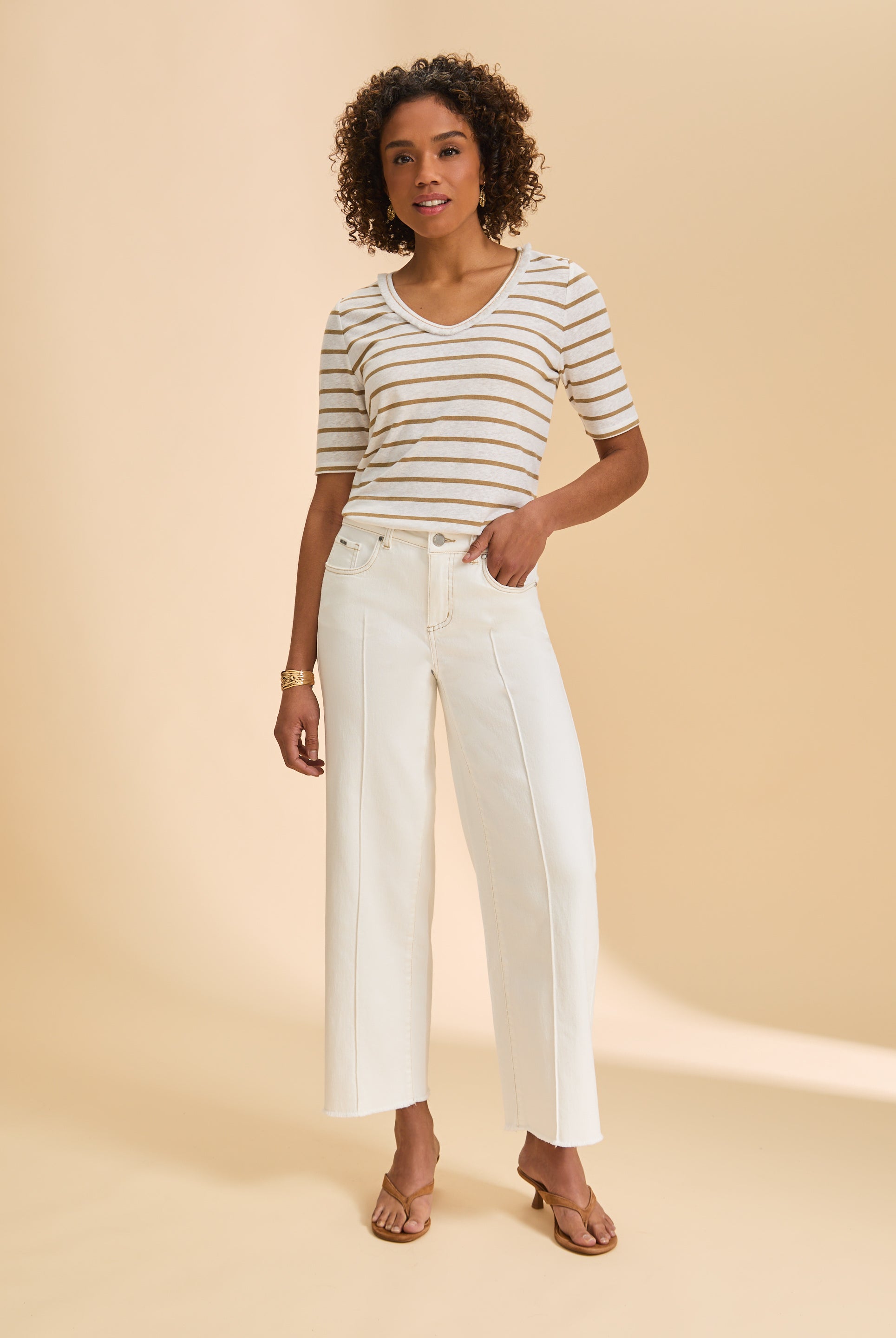 Full outfit with beige striped V-neck top and white pants highlighting neutral tones by French Dressing Jeans (FDJ)