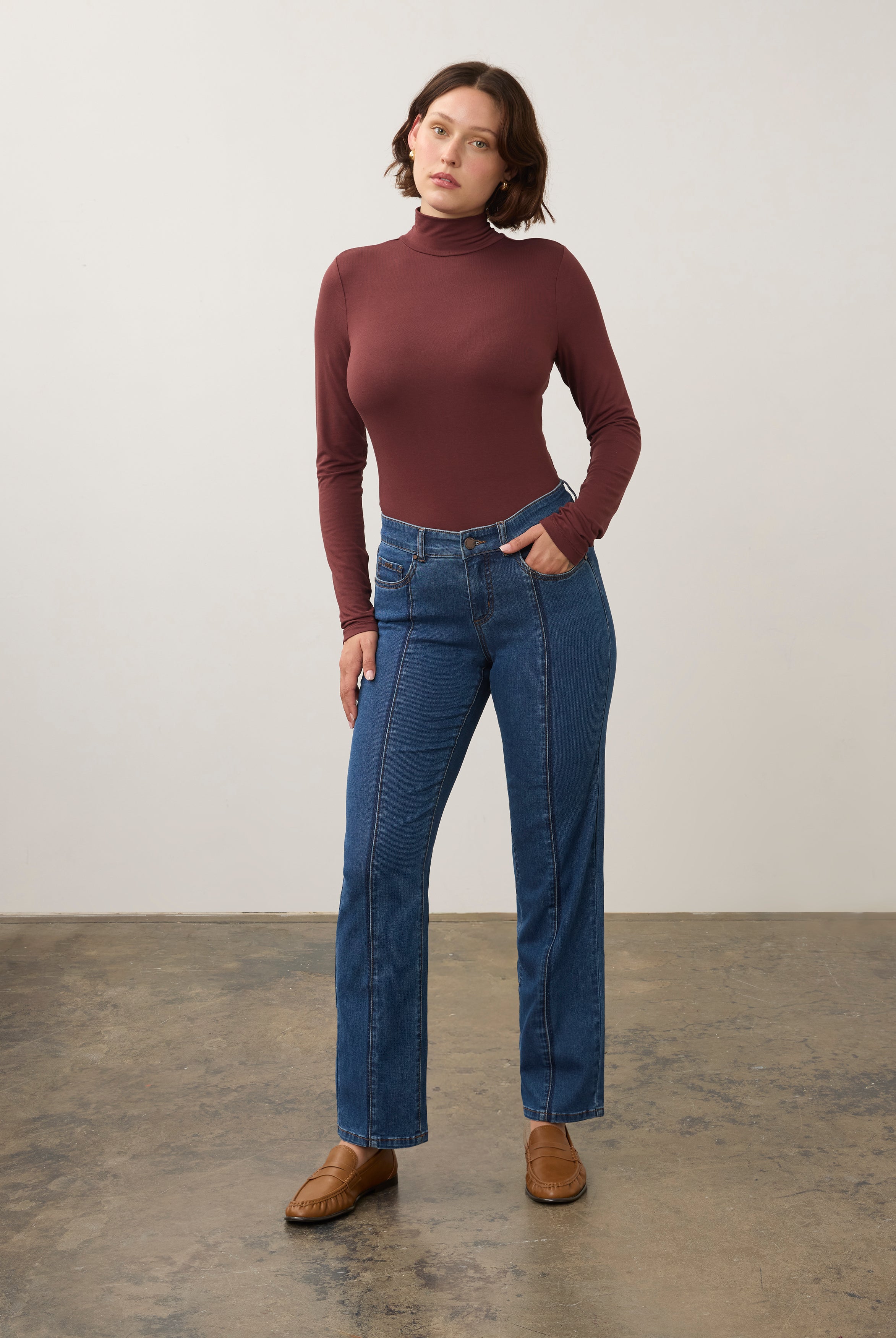 Full body view of burgundy turtleneck top styled with jeans for a modern look by French Dressing Jeans (FDJ)