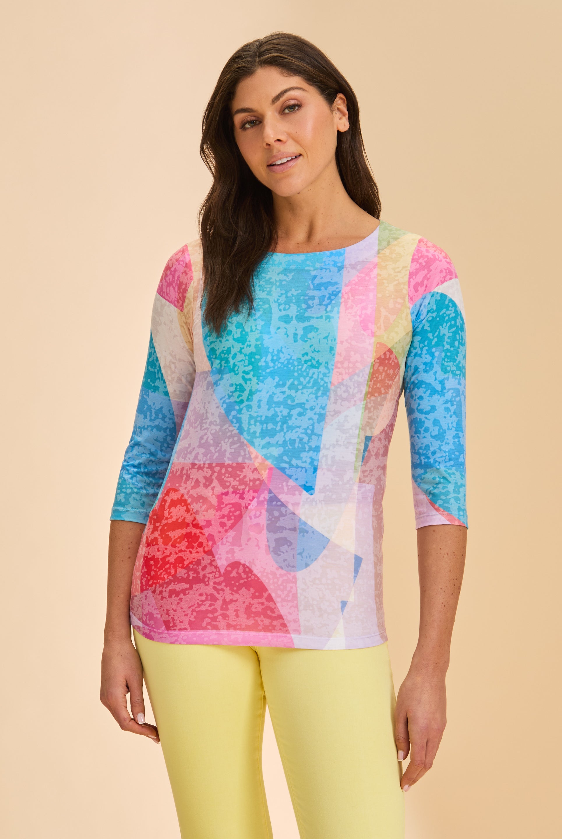 Front view of colorful geometric top with 3/4 sleeves and scoop neck paired with yellow pants by French Dressing Jeans (FDJ)