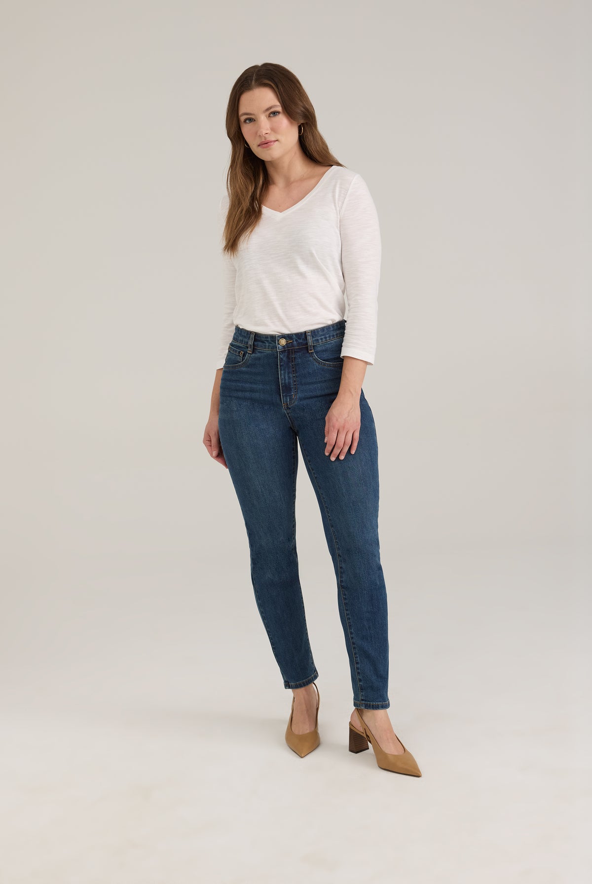 Full view of woman wearing dark wash slim leg jeans with high-rise by French Dressing Jeans (FDJ)
