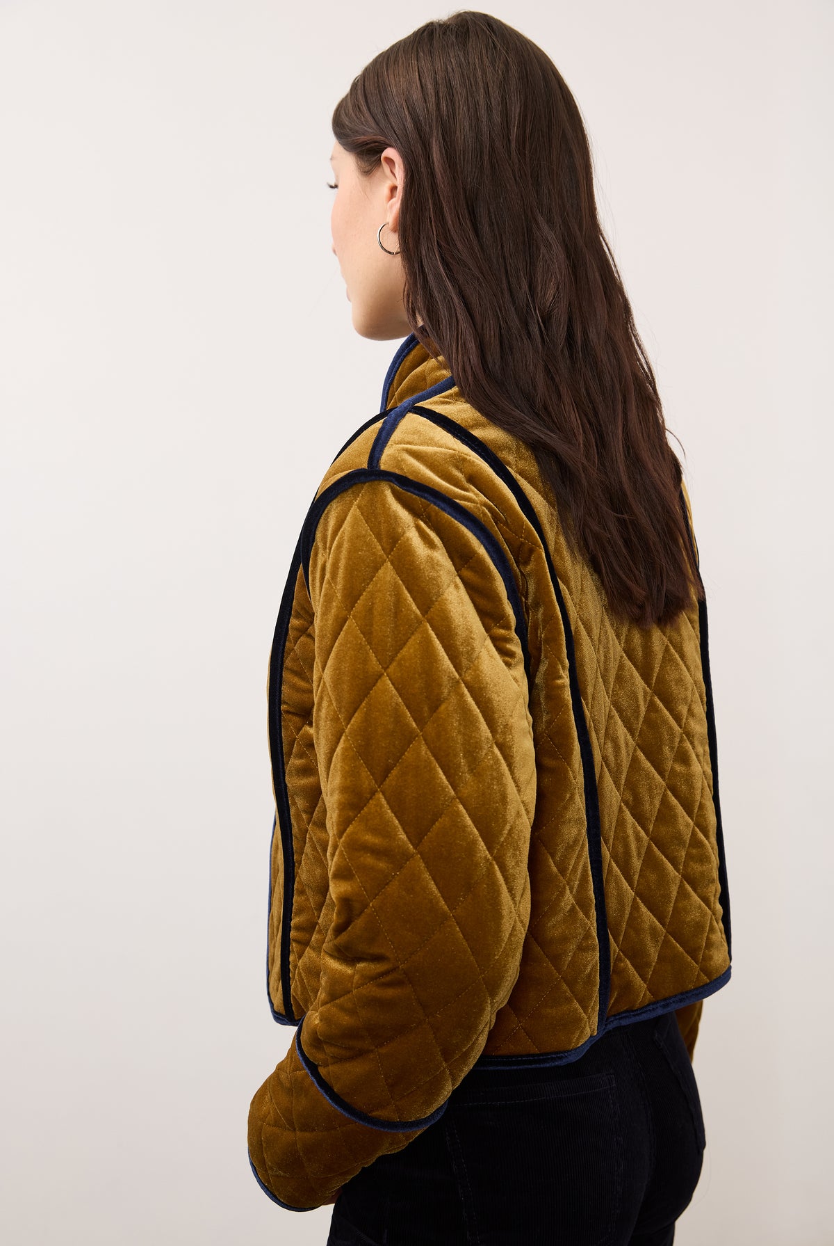 Side view of reversible jacket in brass, displaying quilted pattern and contrasting trim by French Dressing Jeans (FDJ)