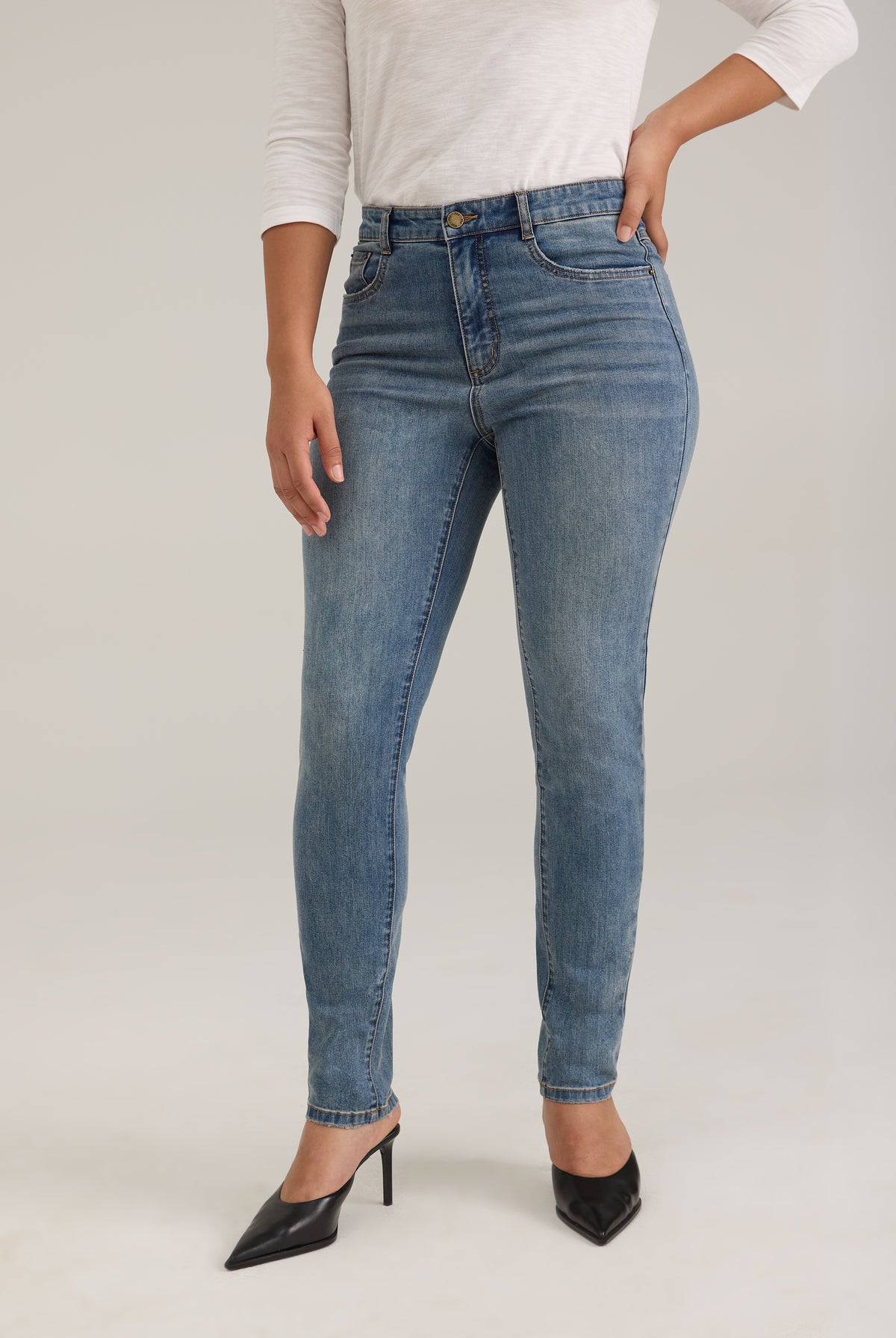 Front view of light wash slim leg jeans with high-rise waist by French Dressing Jeans (FDJ)