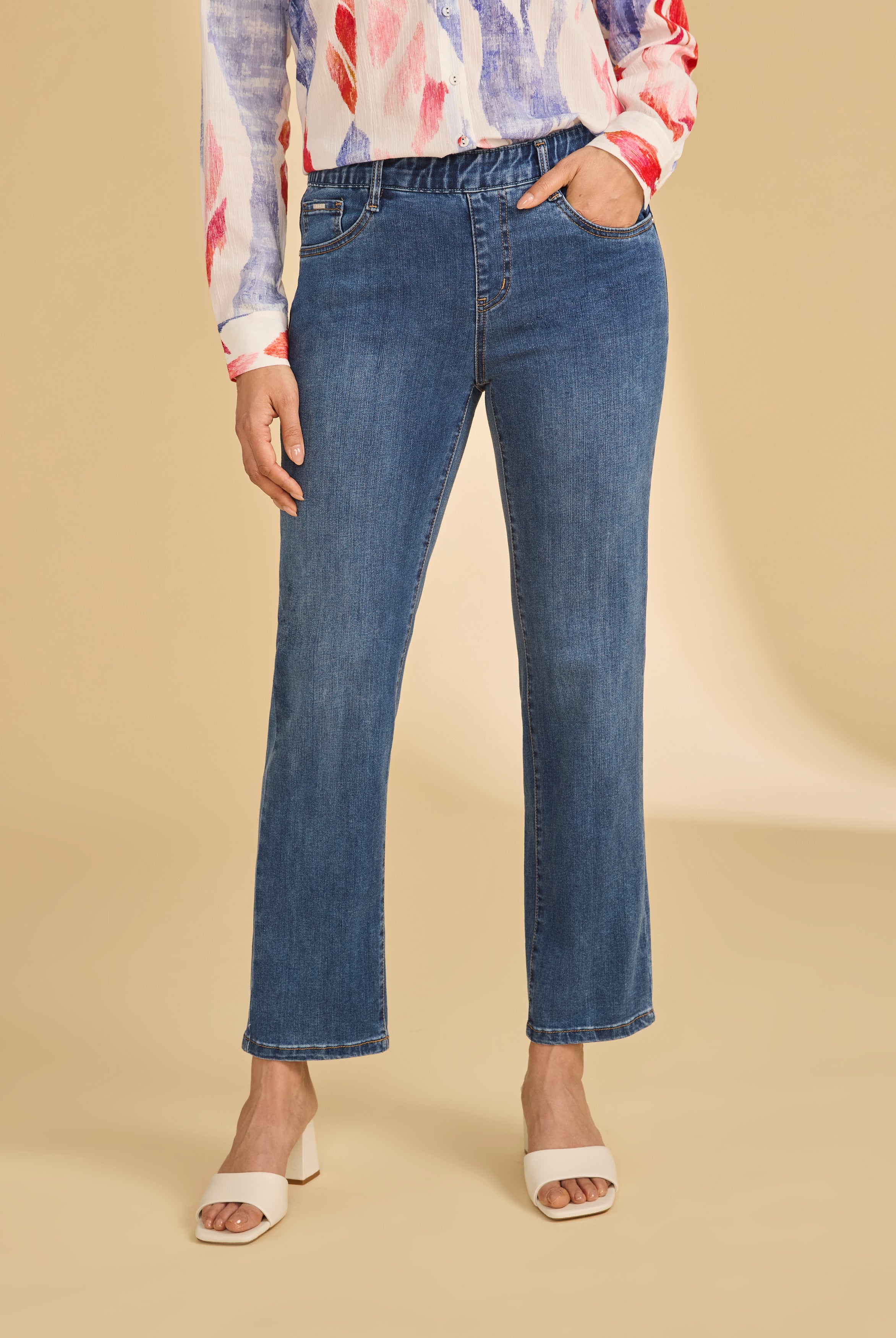 Front view of dark wash pull-on ankle jeans with a classic fit and vibrant blouse by French Dressing Jeans (FDJ)