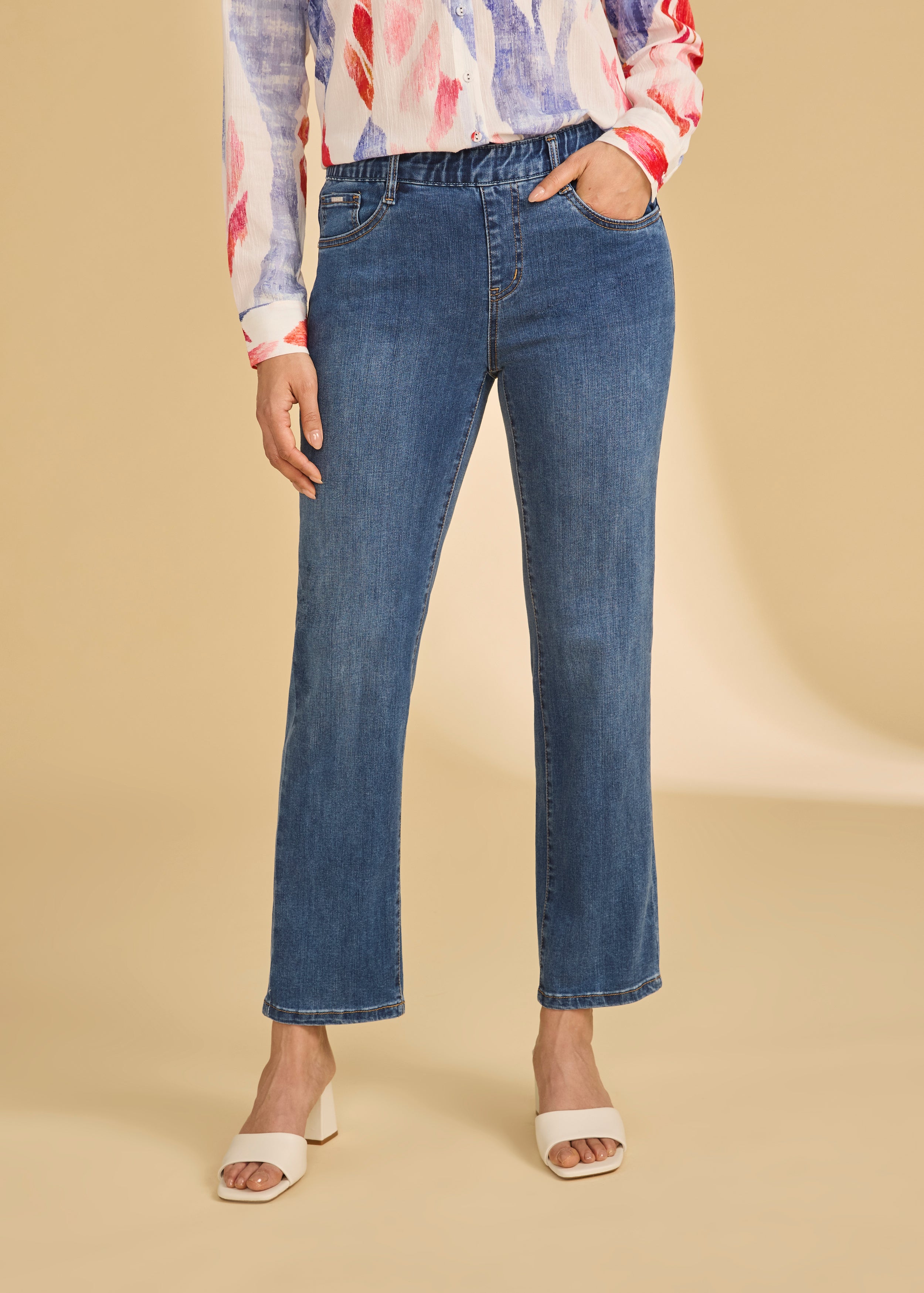 Front view of dark wash pull-on ankle jeans with a classic fit and vibrant blouse by French Dressing Jeans (FDJ)