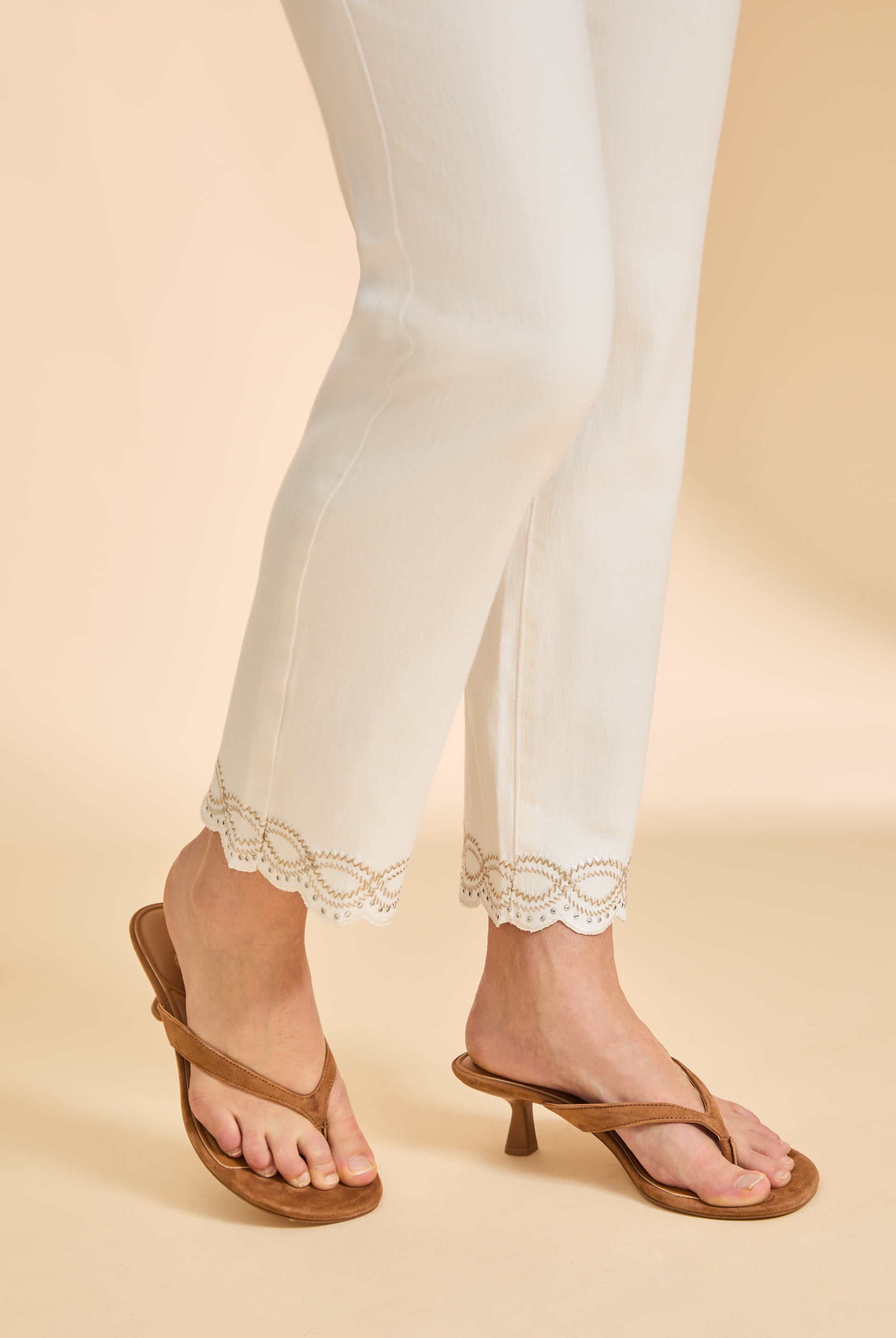 Side detail of ivory Suzanne denim showing lace hem and slim fit leg by French Dressing Jeans (FDJ)