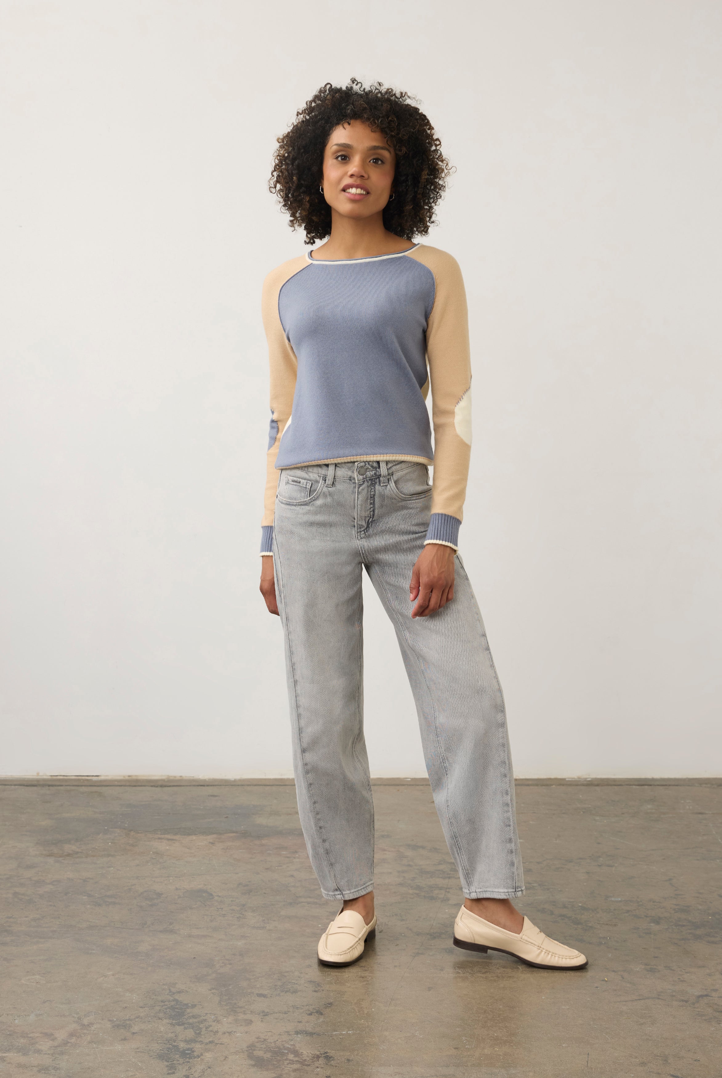 Model in colorblock sweater with light denim jeans, full outfit view by French Dressing Jeans (FDJ)