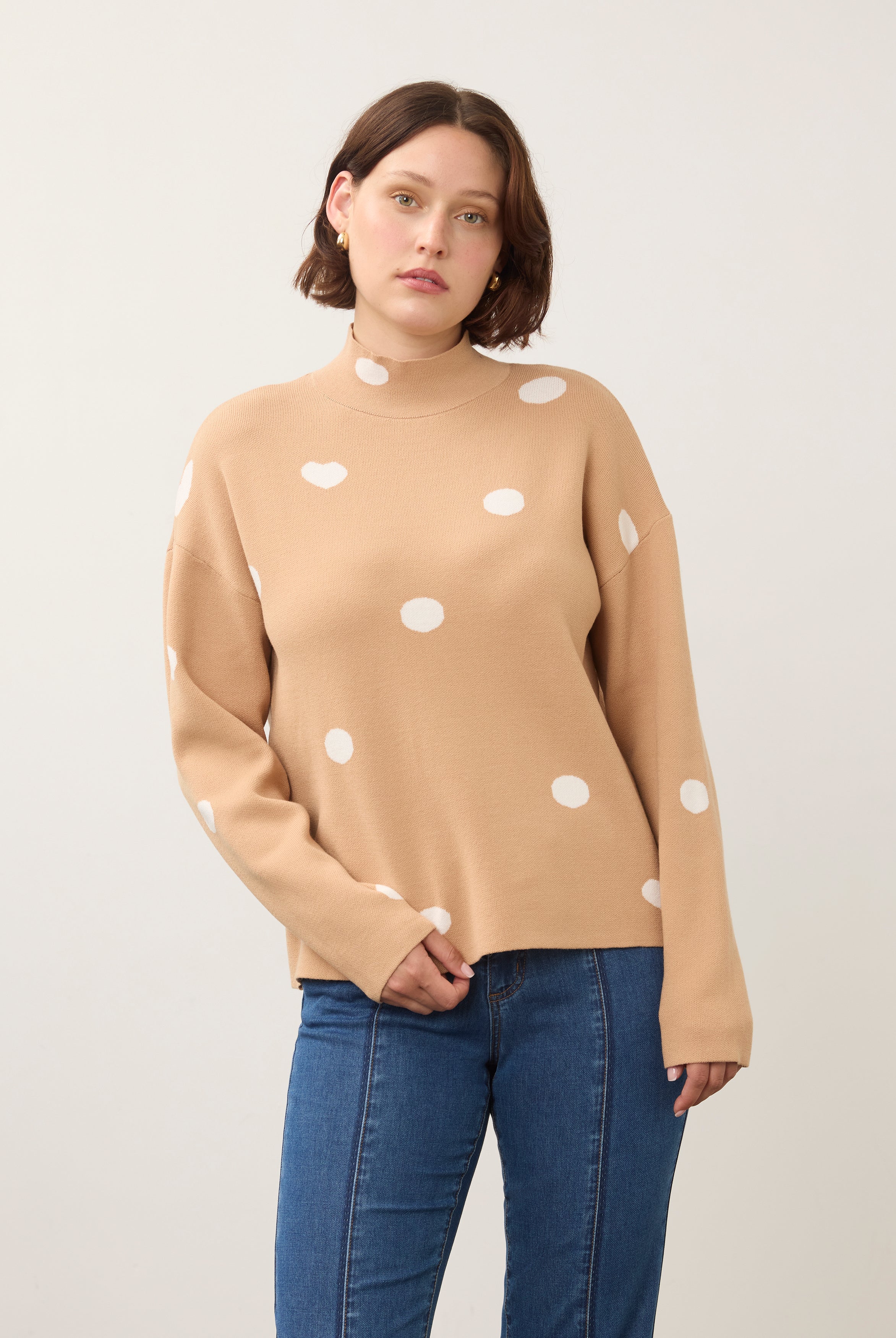 Front view of tan polka dot sweater with high collar and long sleeves by French Dressing Jeans (FDJ)