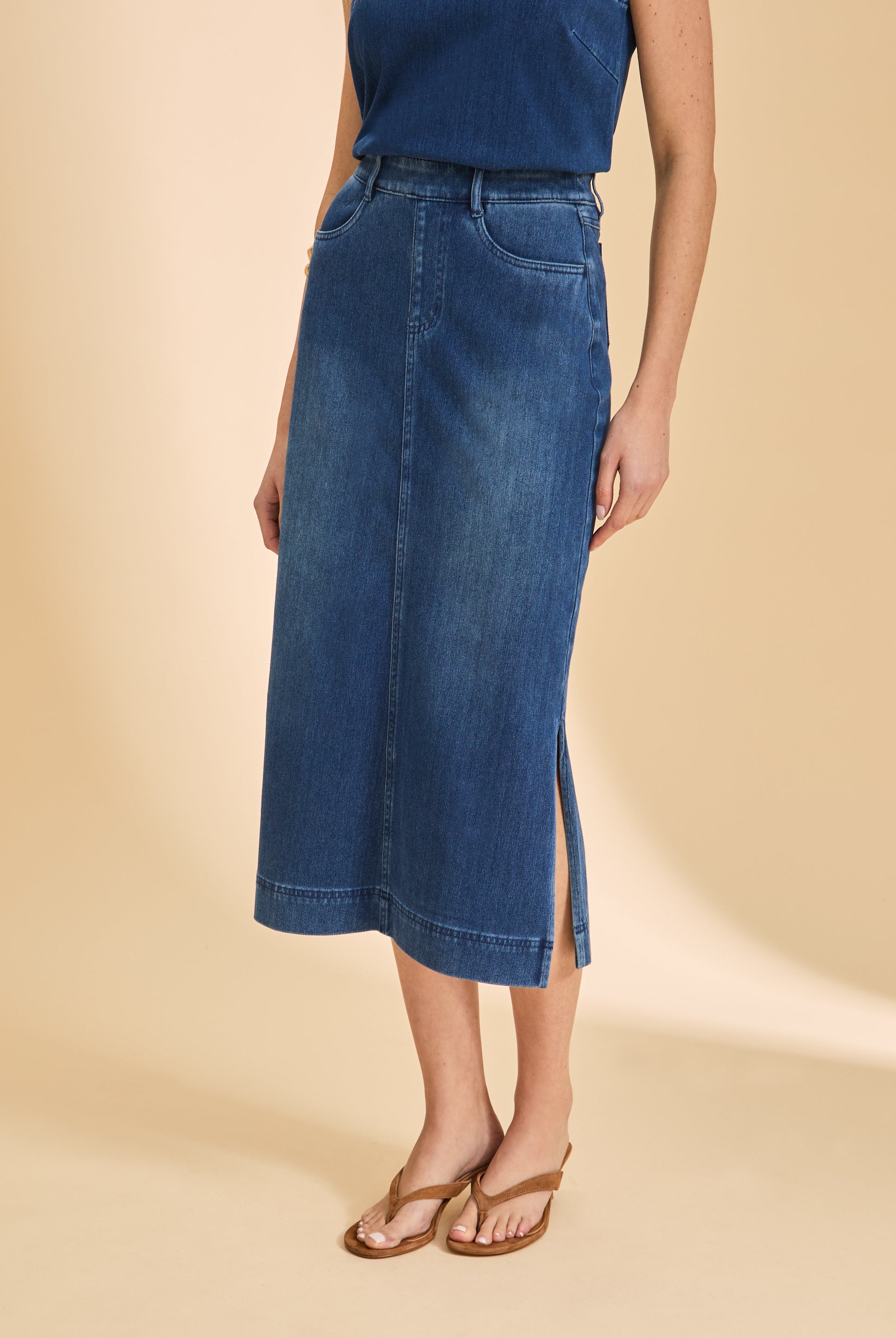 Close-up of blue denim skirt showing front seam and side slit by French Dressing Jeans (FDJ)