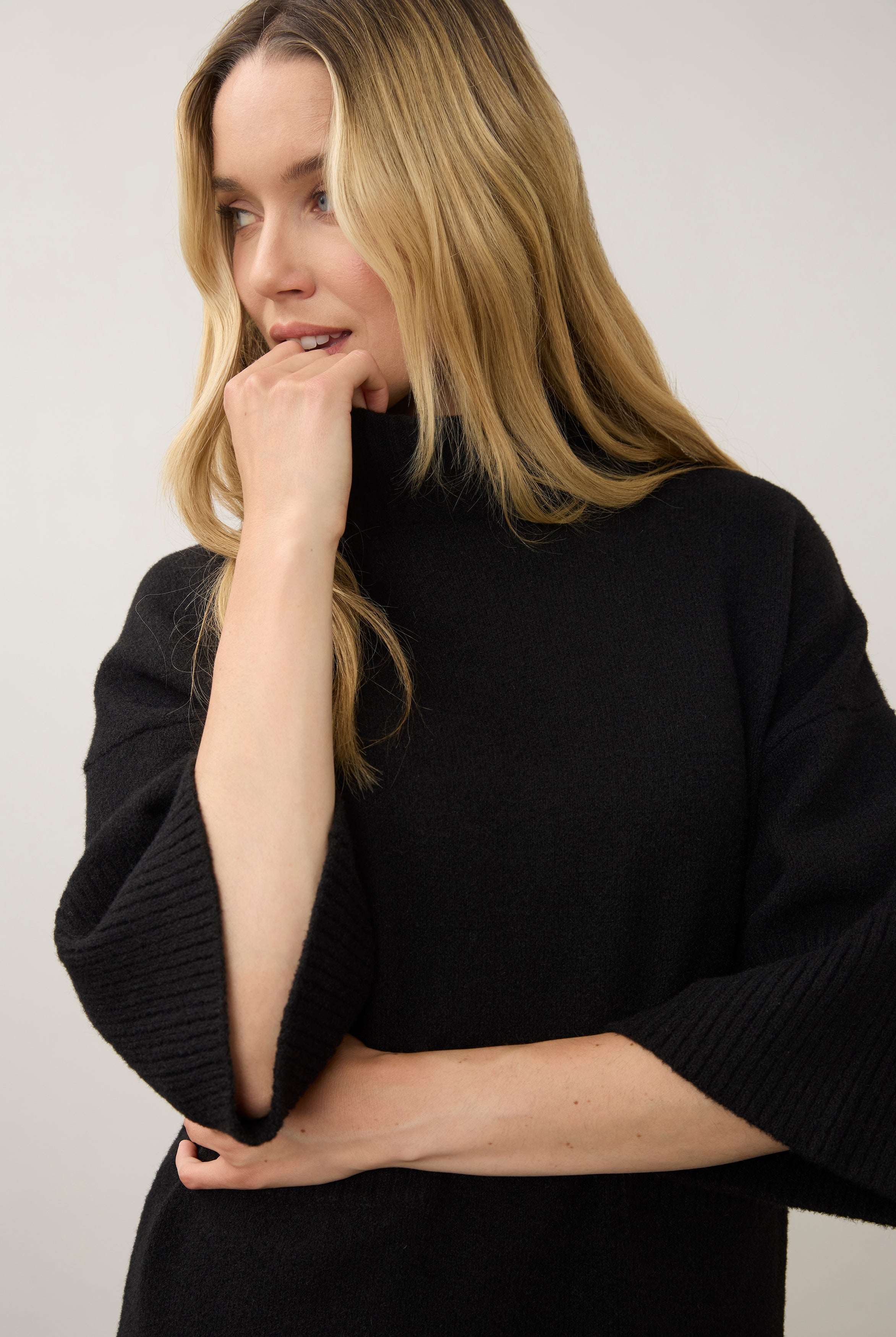 Close-up of black tunic sweater highlighting ribbed sleeve detail by French Dressing Jeans (FDJ)