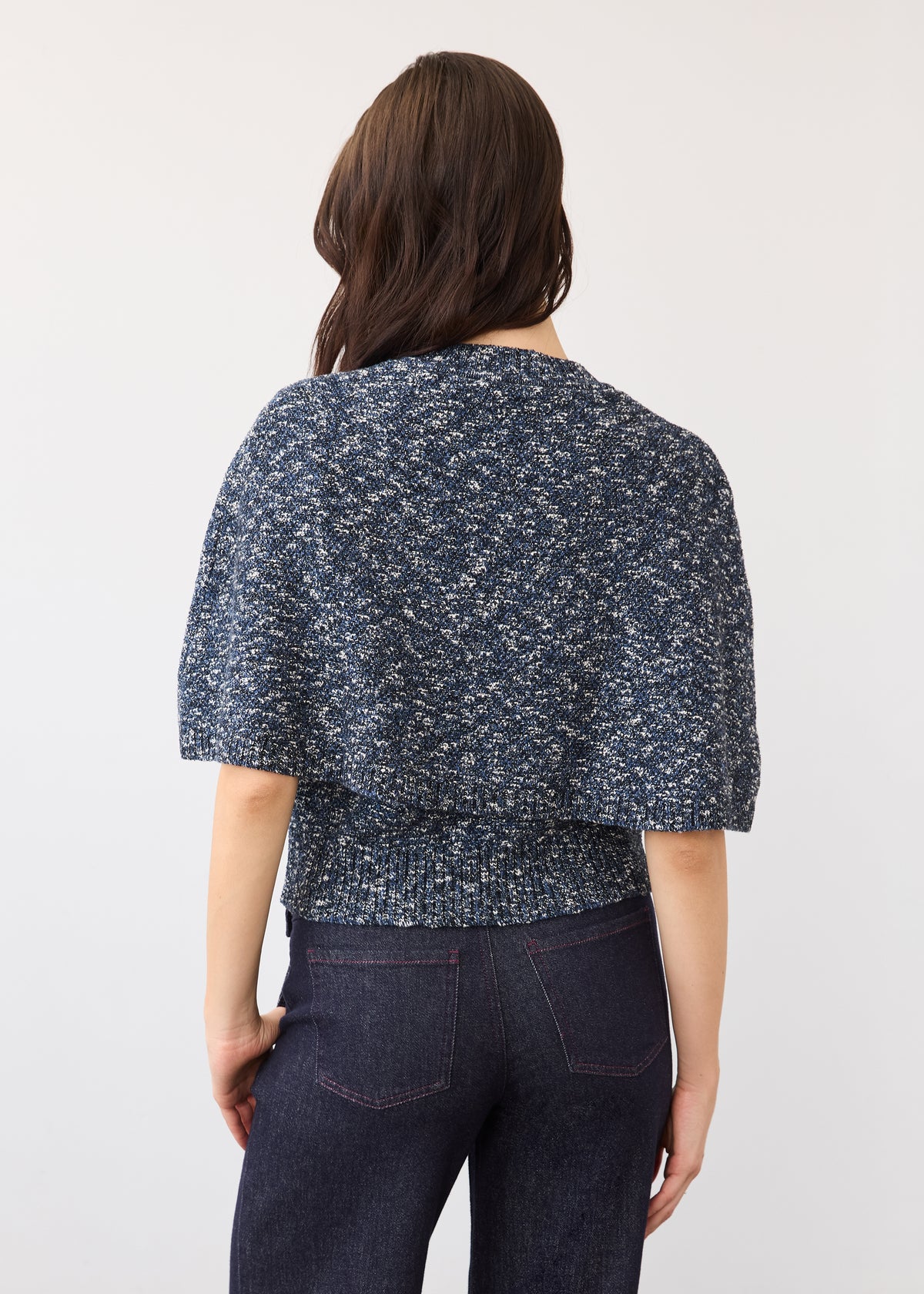 Back view of a textured blue knit top and dark wash denim showcasing back design and fit by French Dressing Jeans (FDJ)