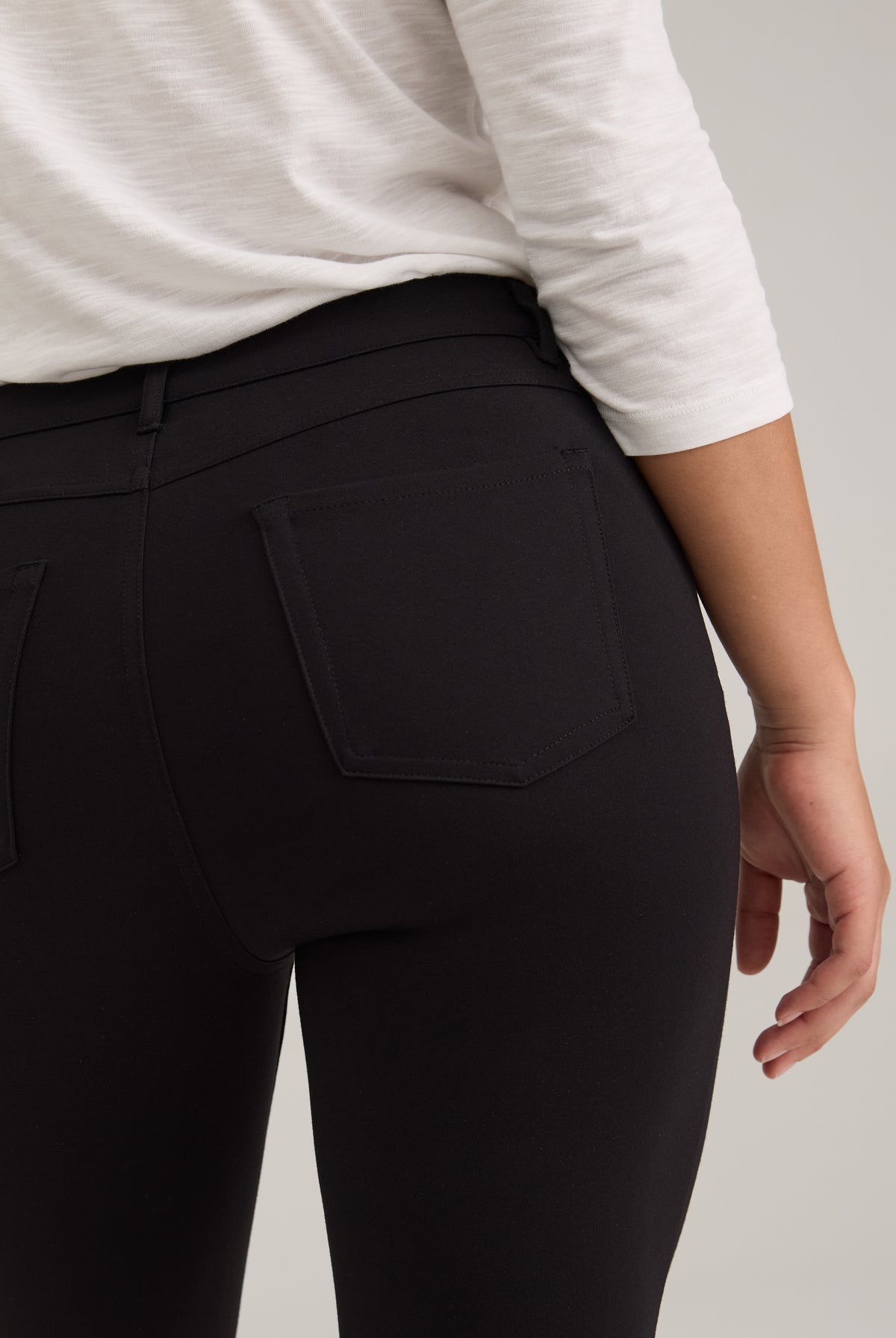 Close-up of black pants showing back patch pockets and fabric by French Dressing Jeans (FDJ)