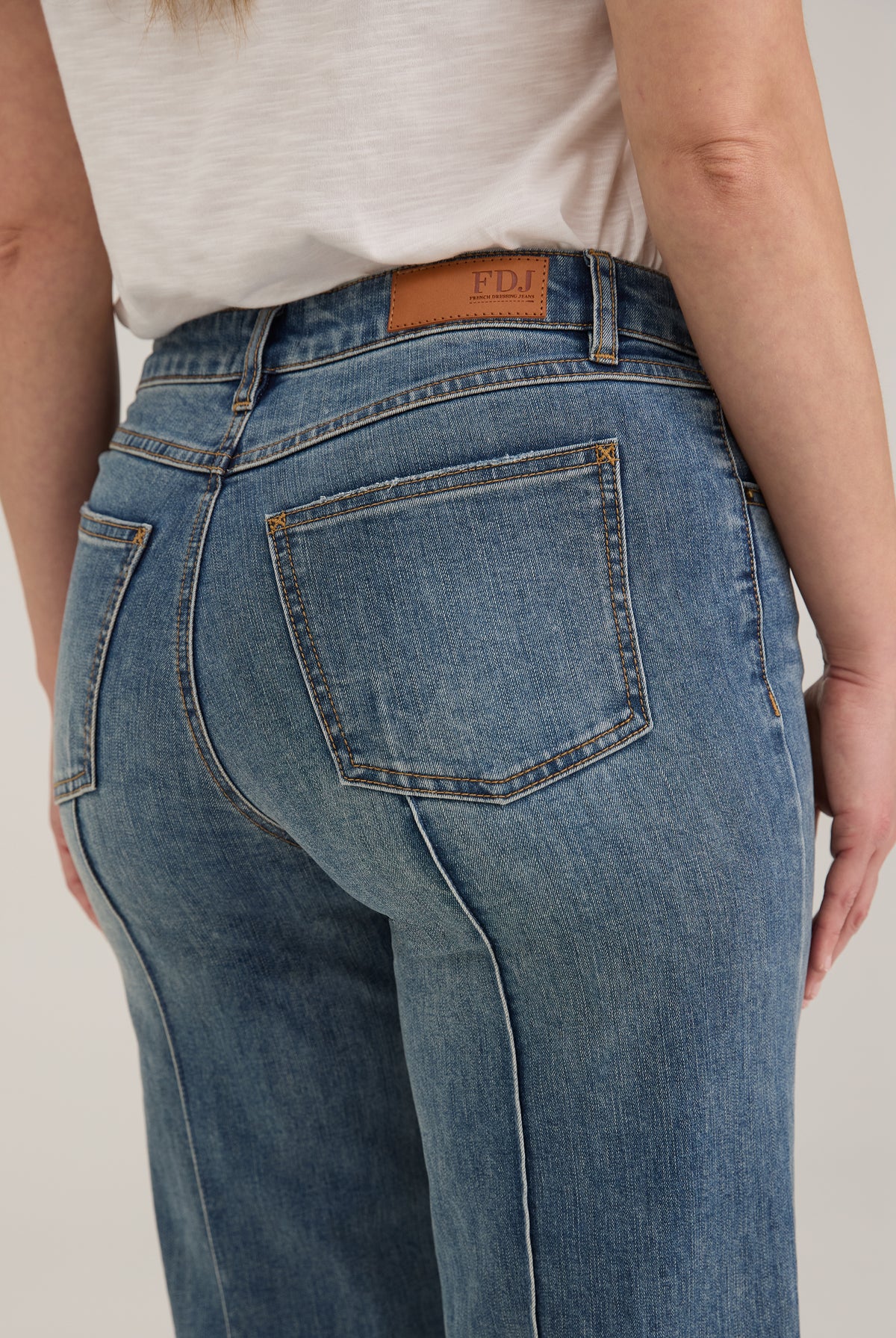 Detail shot of back pockets and waistline on light wash Olivia denim by French Dressing Jeans (FDJ)