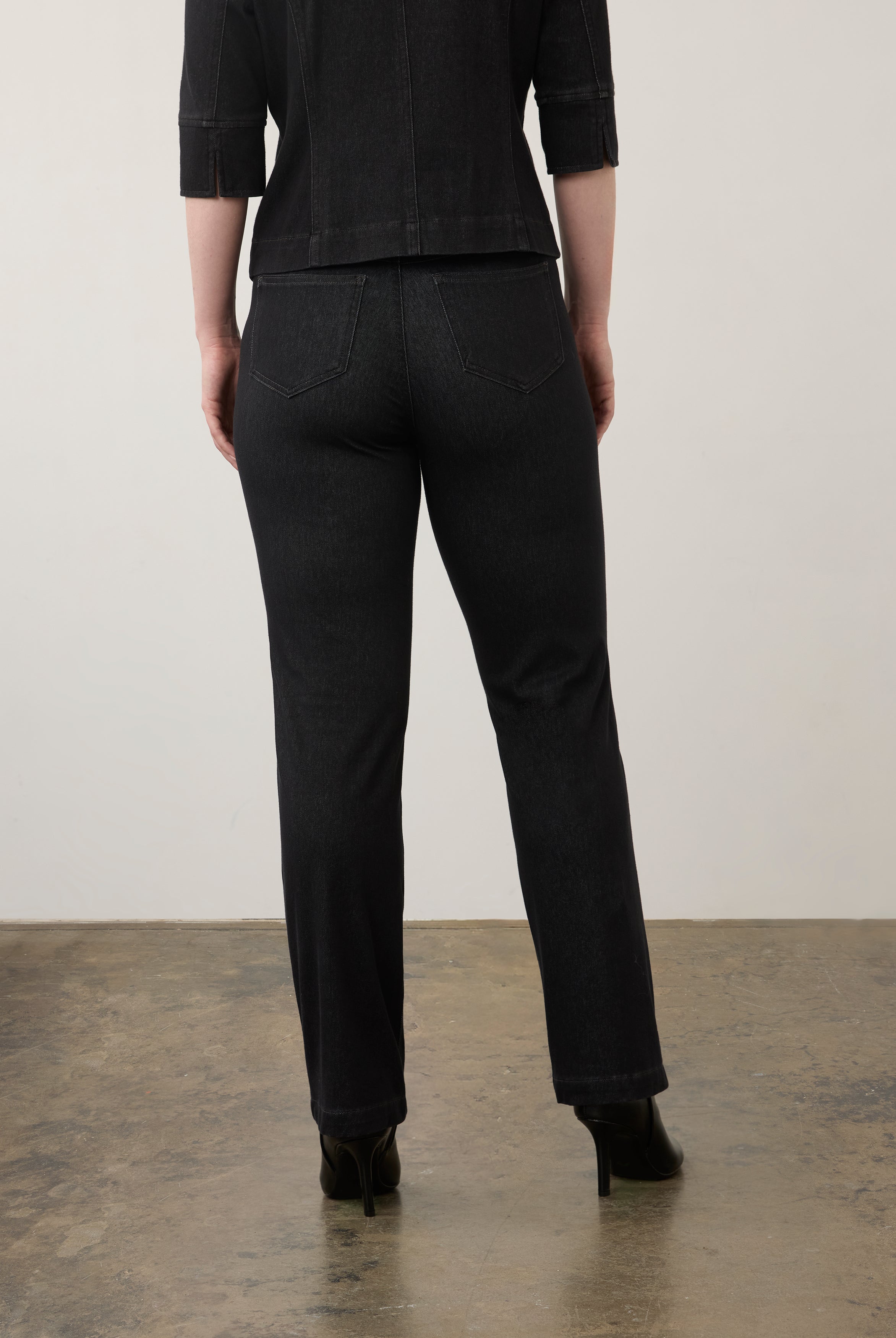 Back view of black straight-leg jeans highlighting rear patch pockets and seam lines by French Dressing Jeans (FDJ)