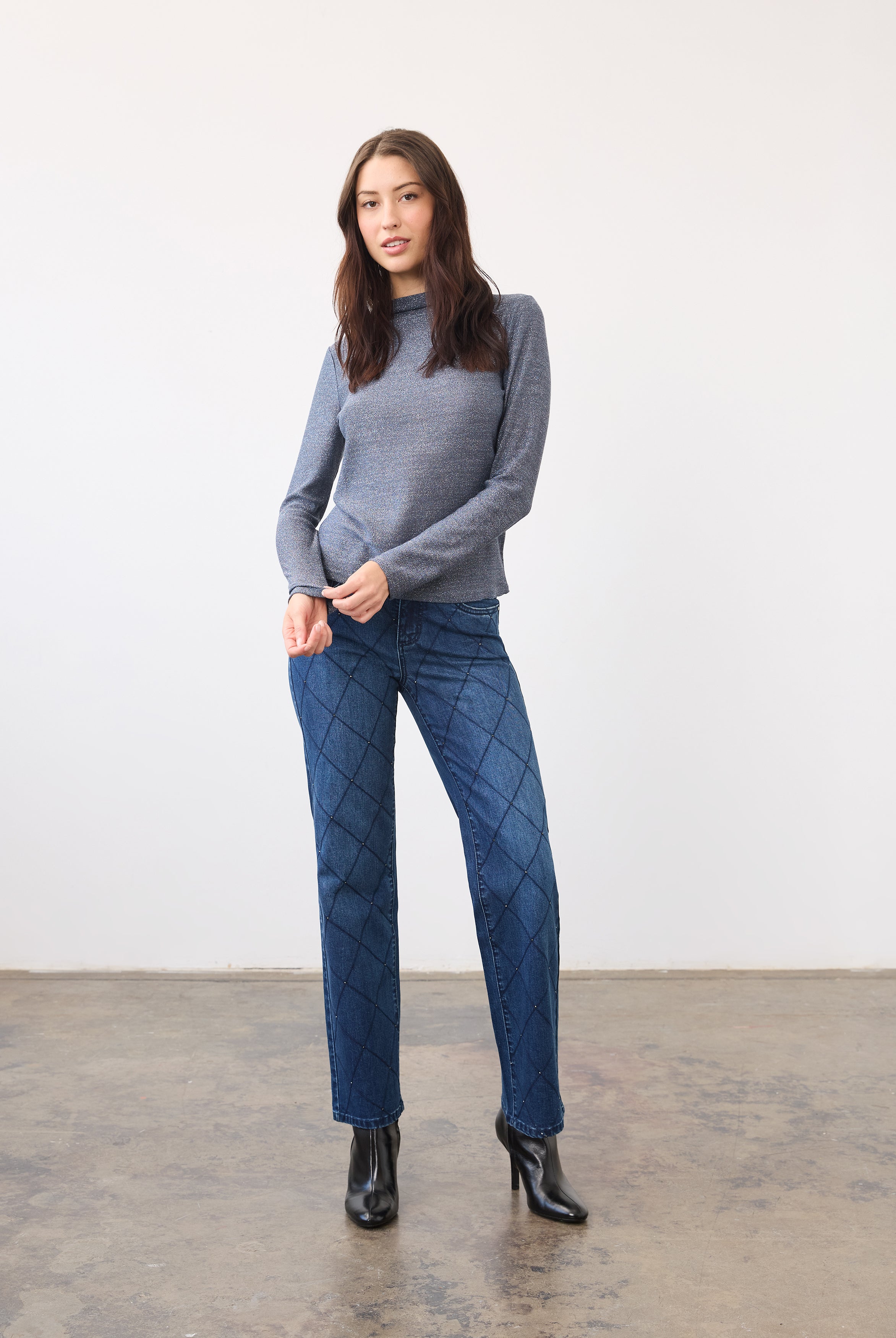 Full view of blue shimmer top paired with patterned jeans and black boots by French Dressing Jeans (FDJ)