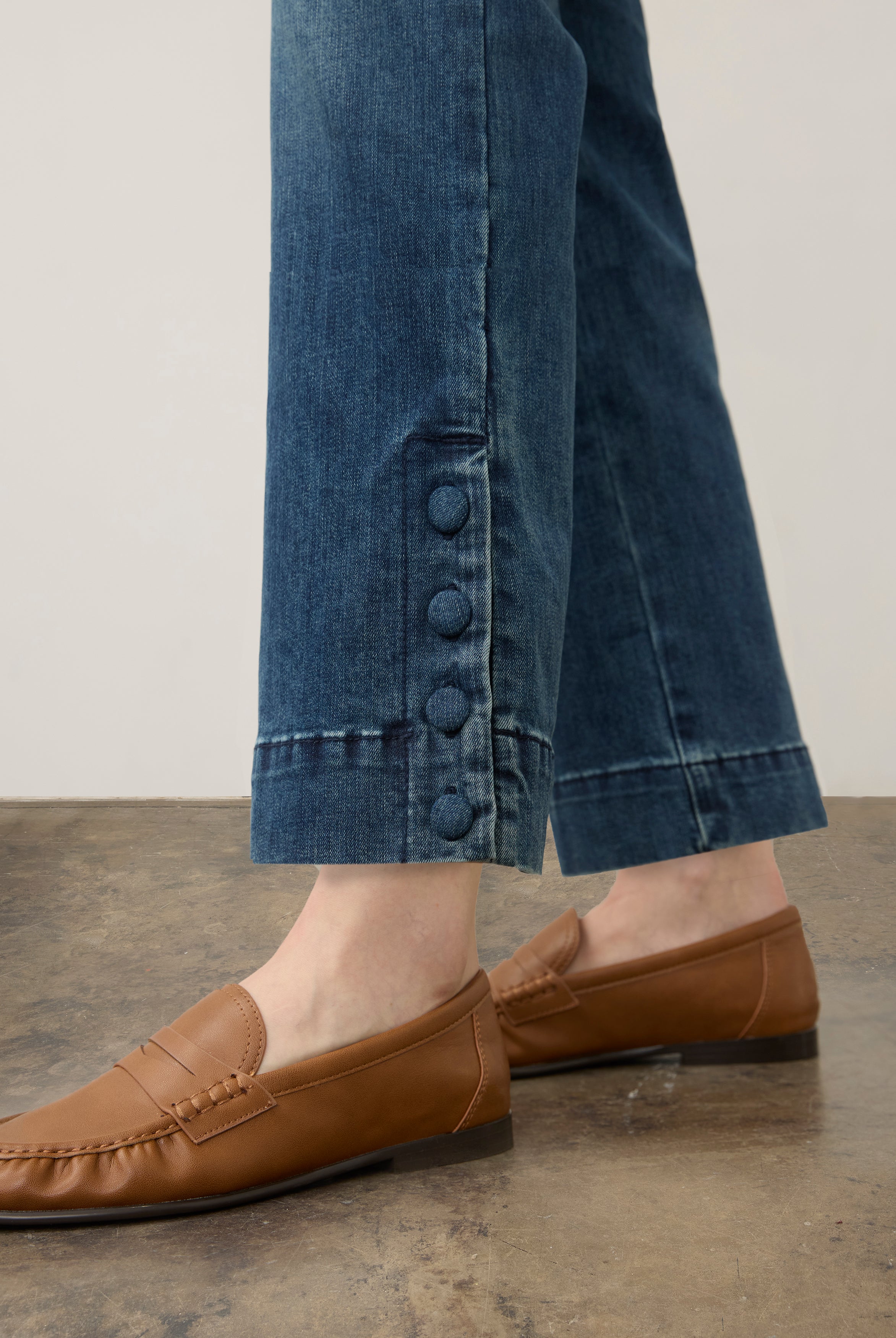 Close-up of medium blue Olivia denim featuring buttoned slit cuffs by French Dressing Jeans (FDJ)
