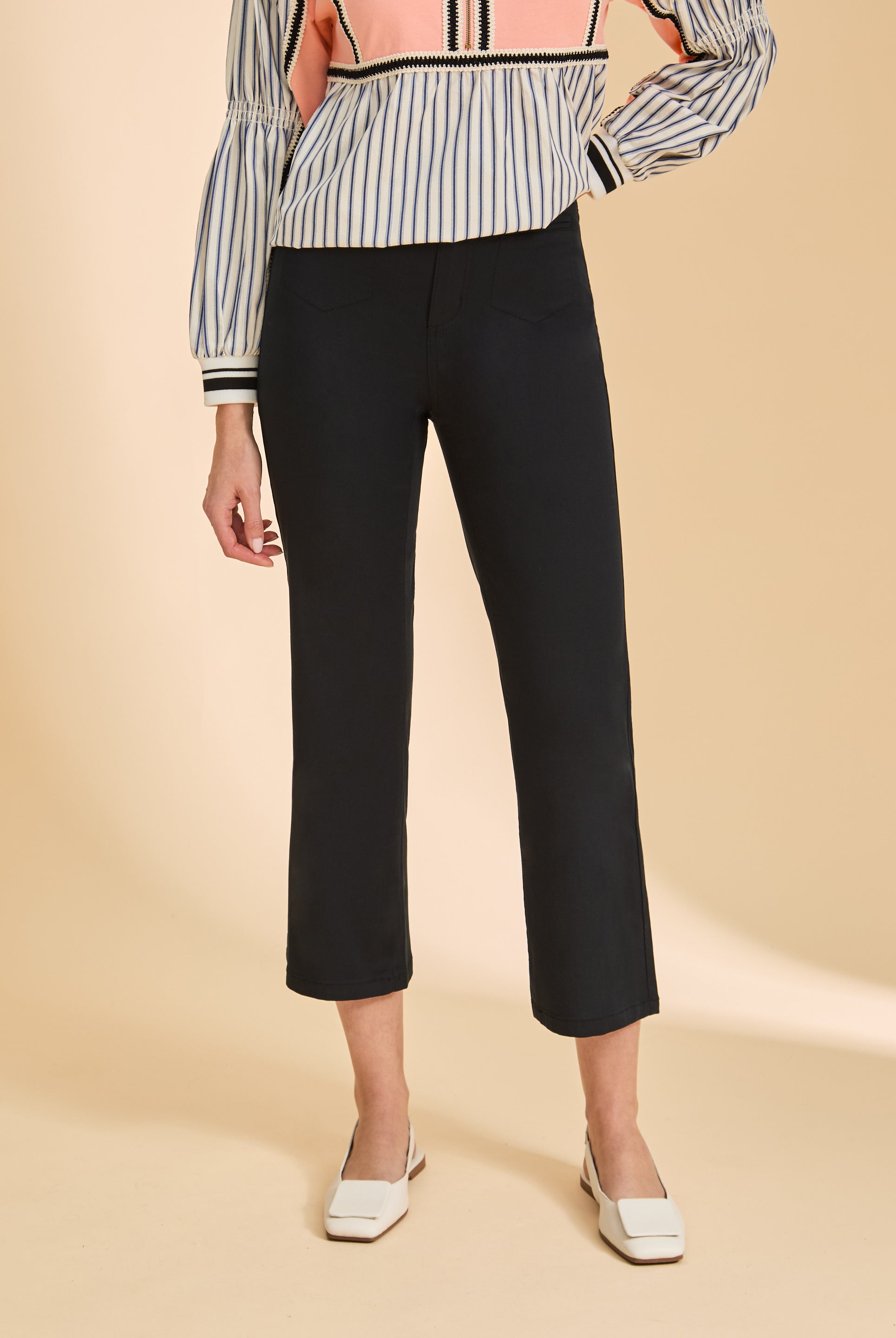 Close-up of black crop pants highlighting sleek silhouette and high-rise fit by French Dressing Jeans (FDJ)