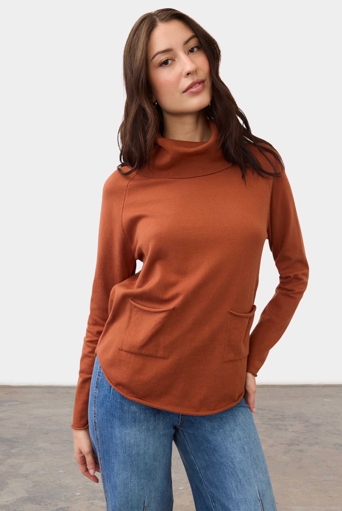Front view of rust sweater with cowl neck and front pockets by French Dressing Jeans (FDJ)