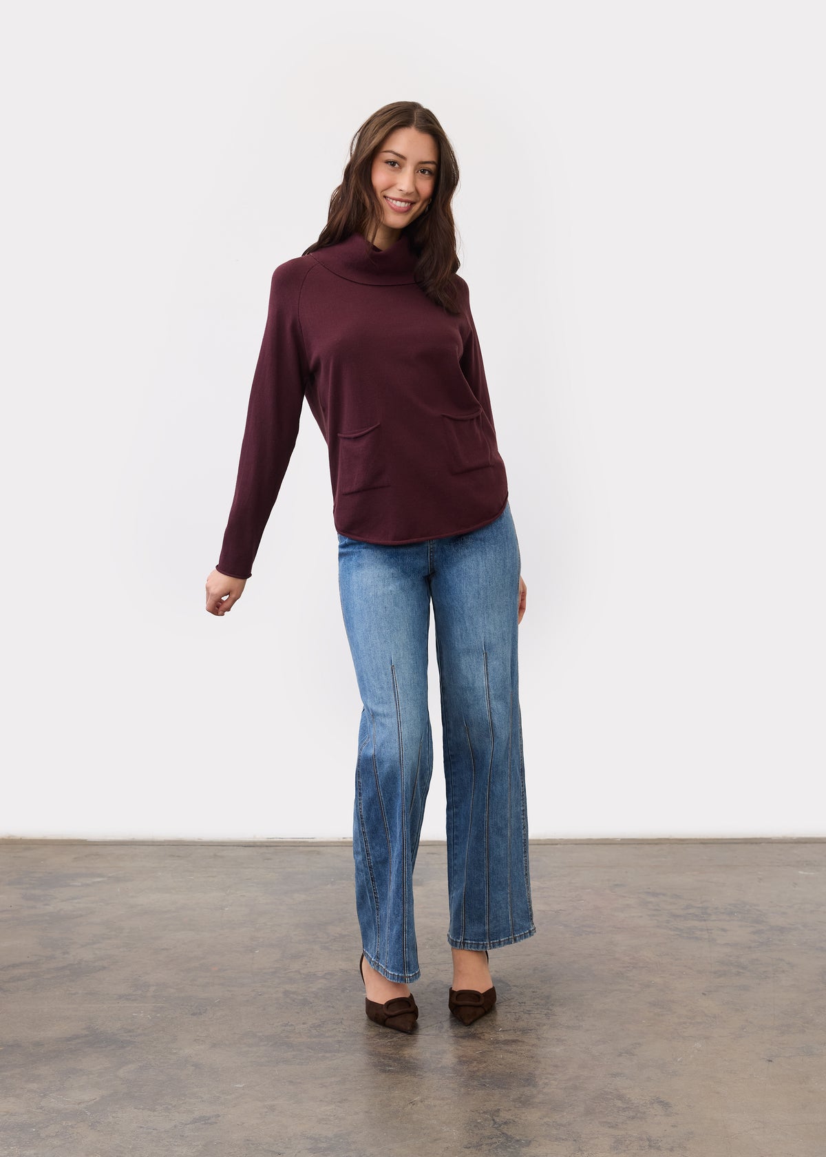 Full-length view of burgundy sweater styled with blue jeans by French Dressing Jeans (FDJ)