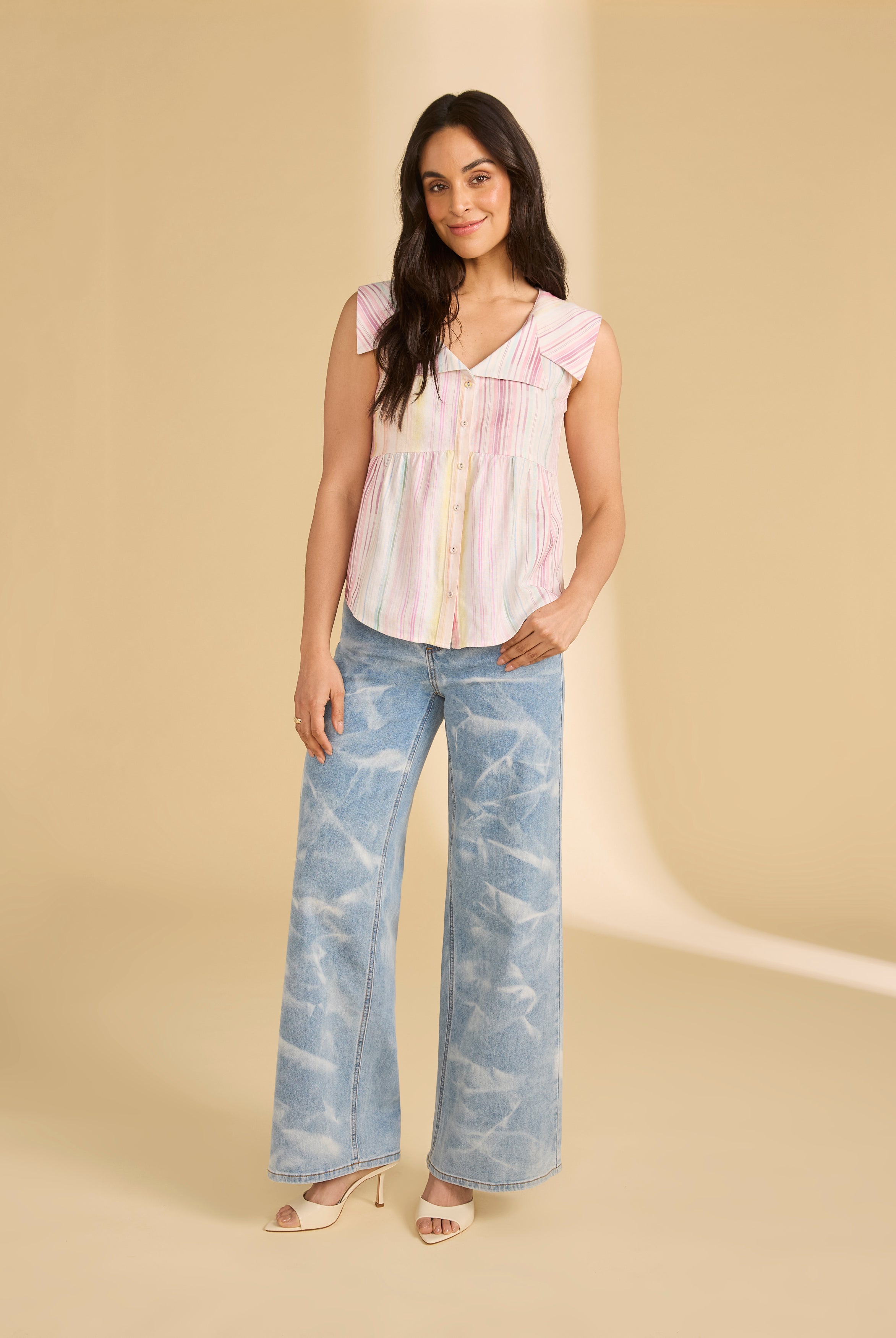 Model in light denim jeans paired with a sleeveless striped top full body view by French Dressing Jeans (FDJ)