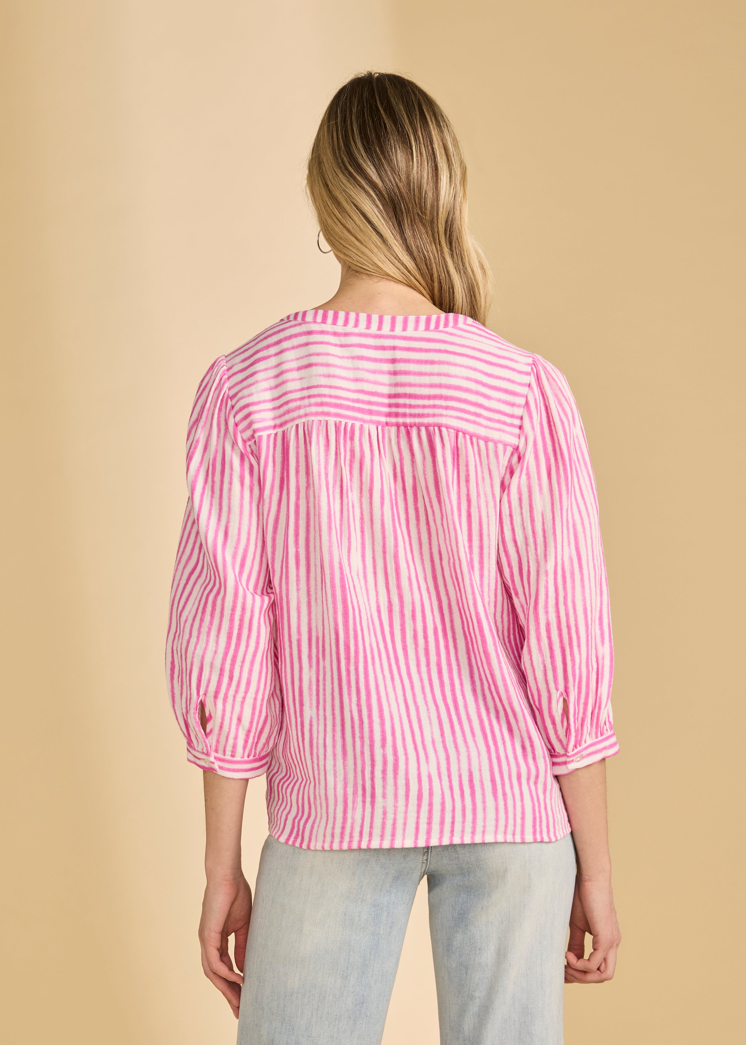 Back view of pink striped blouse highlighting yoke and pleats by French Dressing Jeans (FDJ)