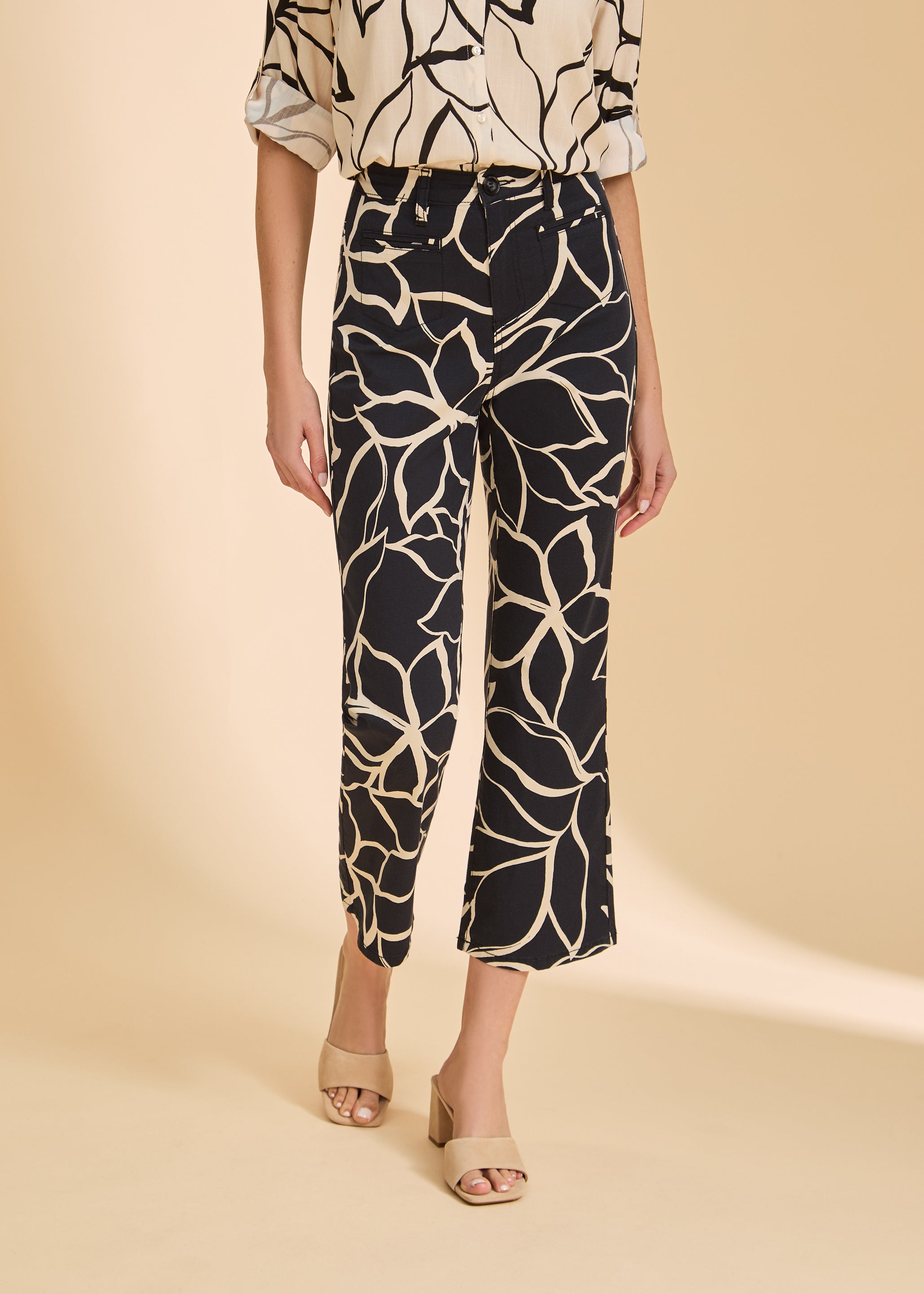 Close-up of black plumeria crop pants showcasing floral print and high-rise waist by French Dressing Jeans (FDJ)