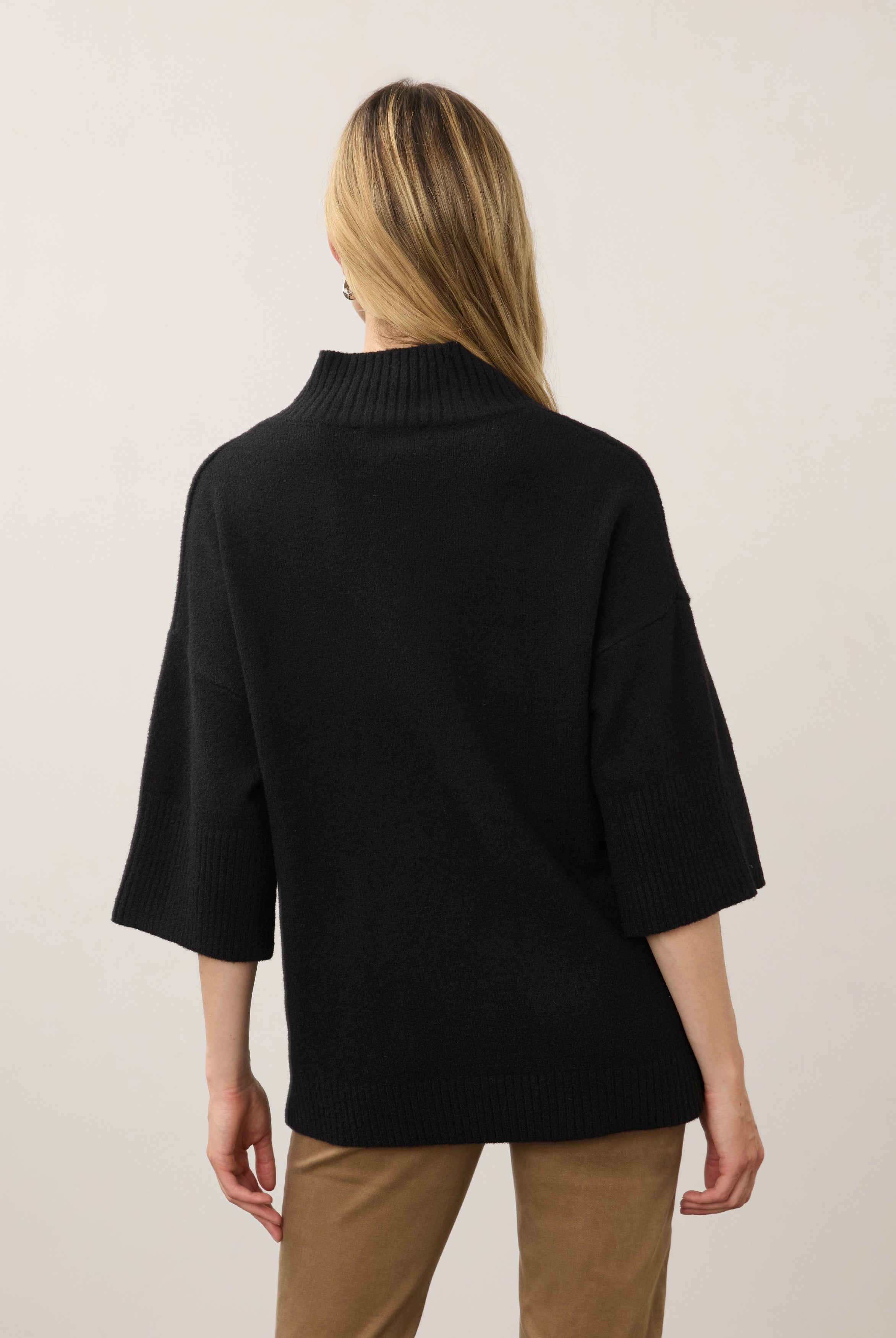 Back view of black tunic sweater showcasing relaxed fit and ribbed collar by French Dressing Jeans (FDJ)
