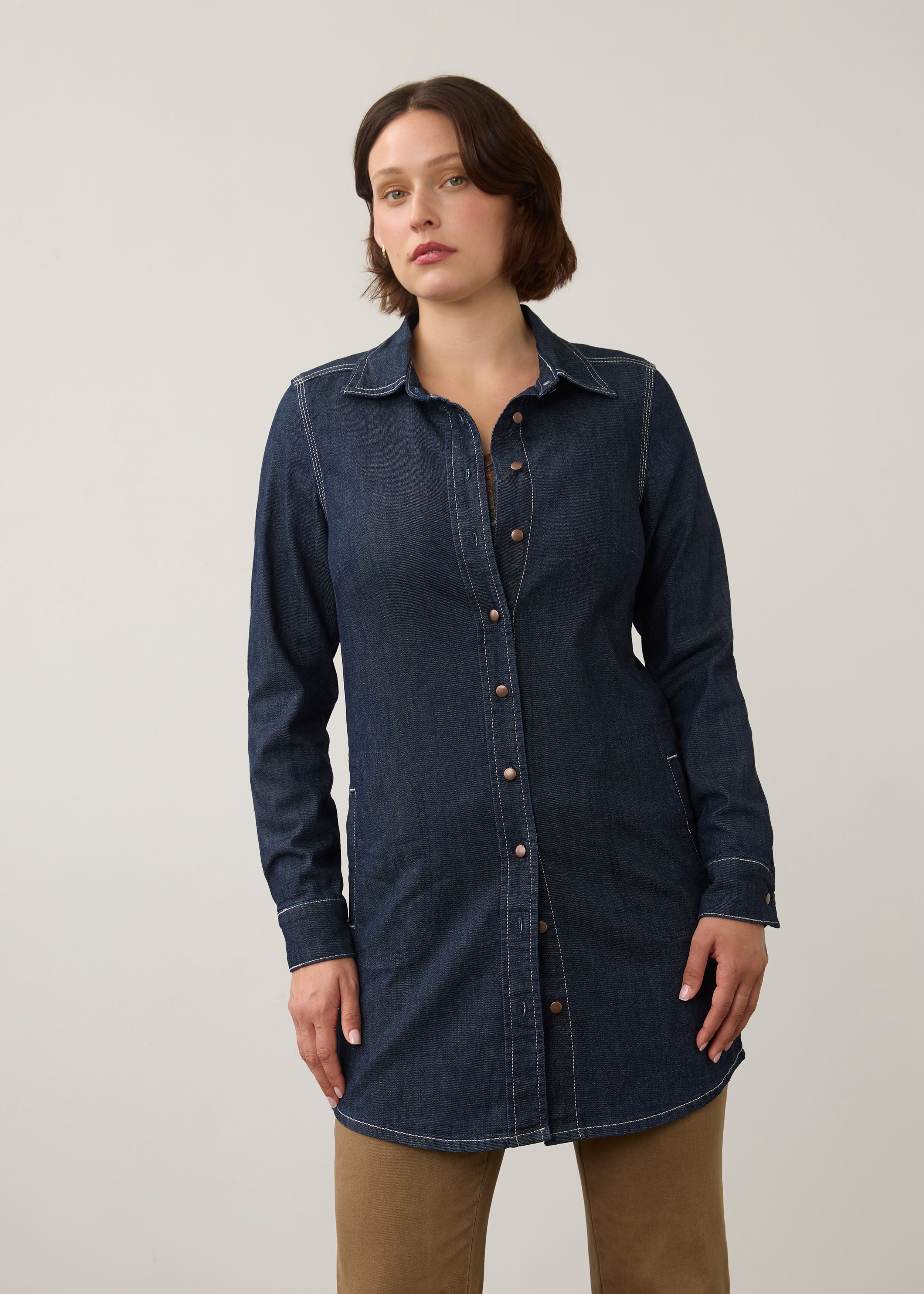 Front view of dark wash long denim tunic with button closure and side patch pockets by French Dressing Jeans (FDJ)