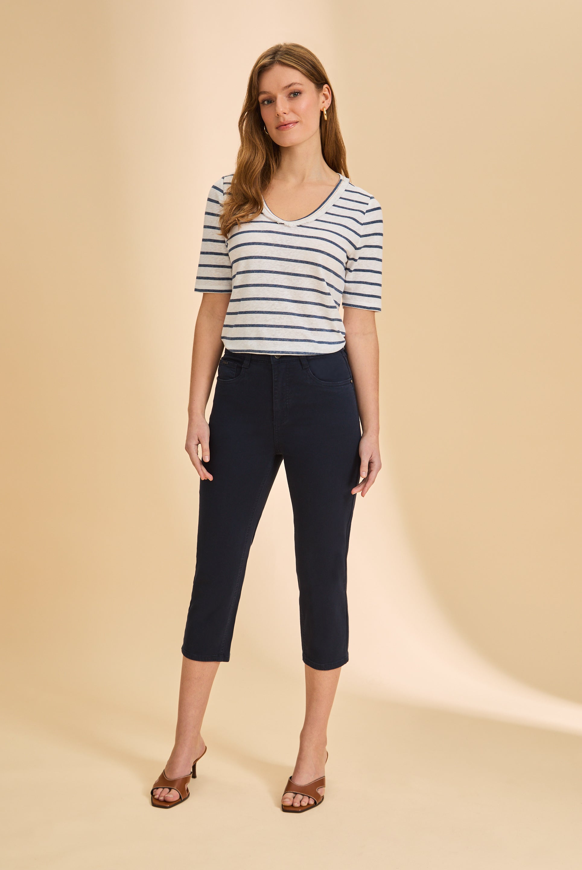 Full outfit with blue striped V-neck top and dark pants for a sleek look by French Dressing Jeans (FDJ)