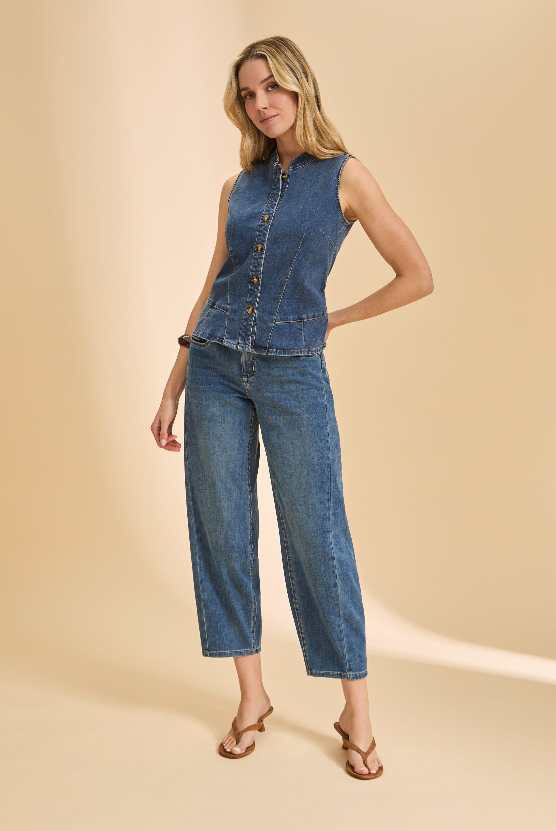 Full body view of dark wash denim ensemble with sleeveless top and wide-leg jeans by French Dressing Jeans (FDJ)