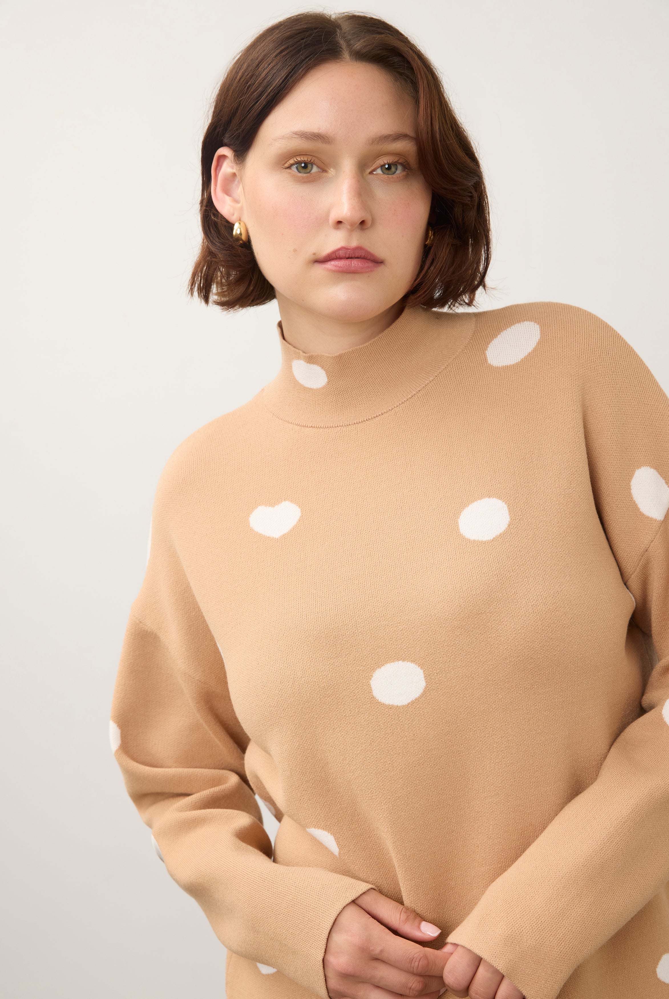 Close-up of tan polka dot sweater with high collar detail by French Dressing Jeans (FDJ)