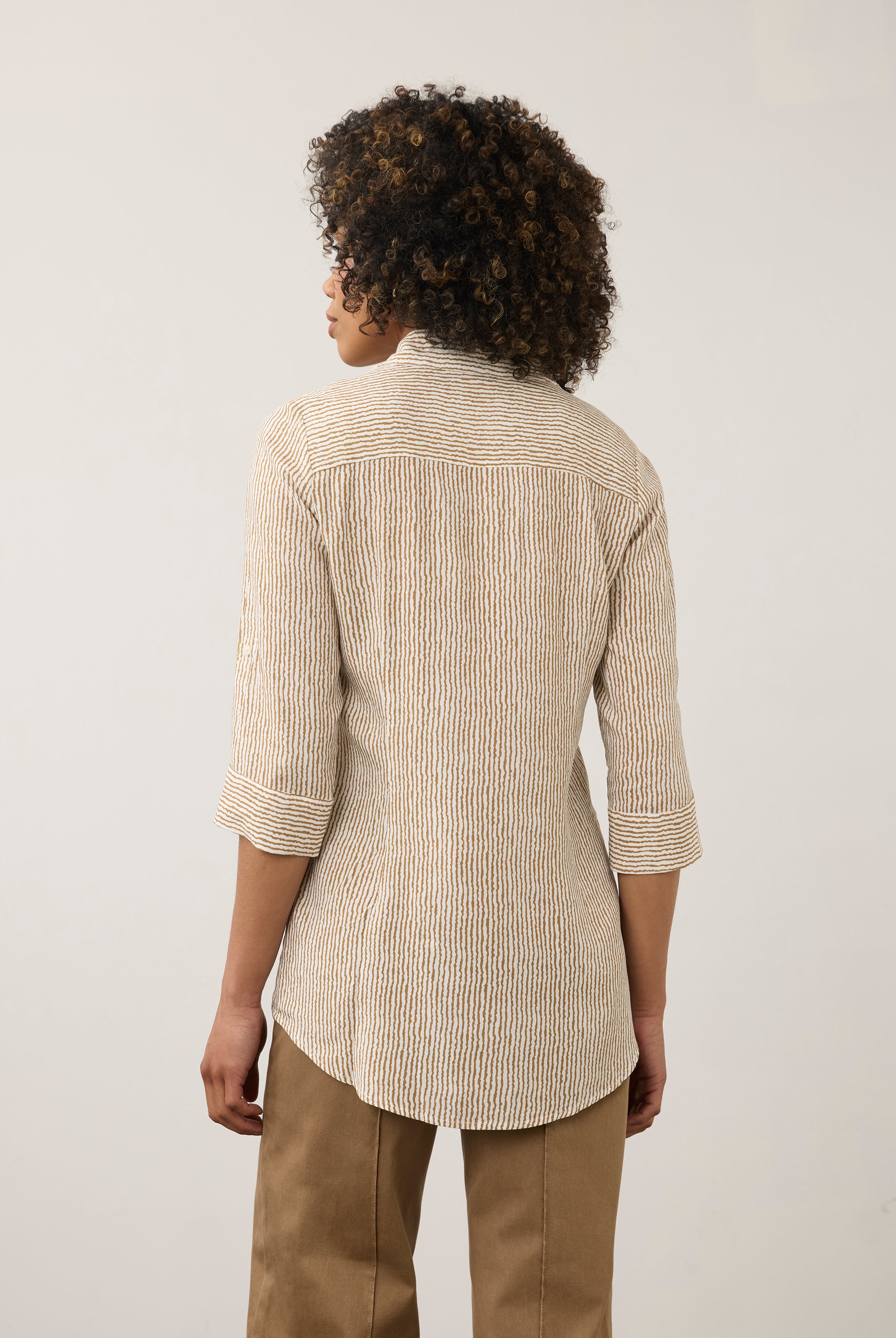 Back view of striped beige and white shirt highlighting long sleeves by French Dressing Jeans (FDJ)