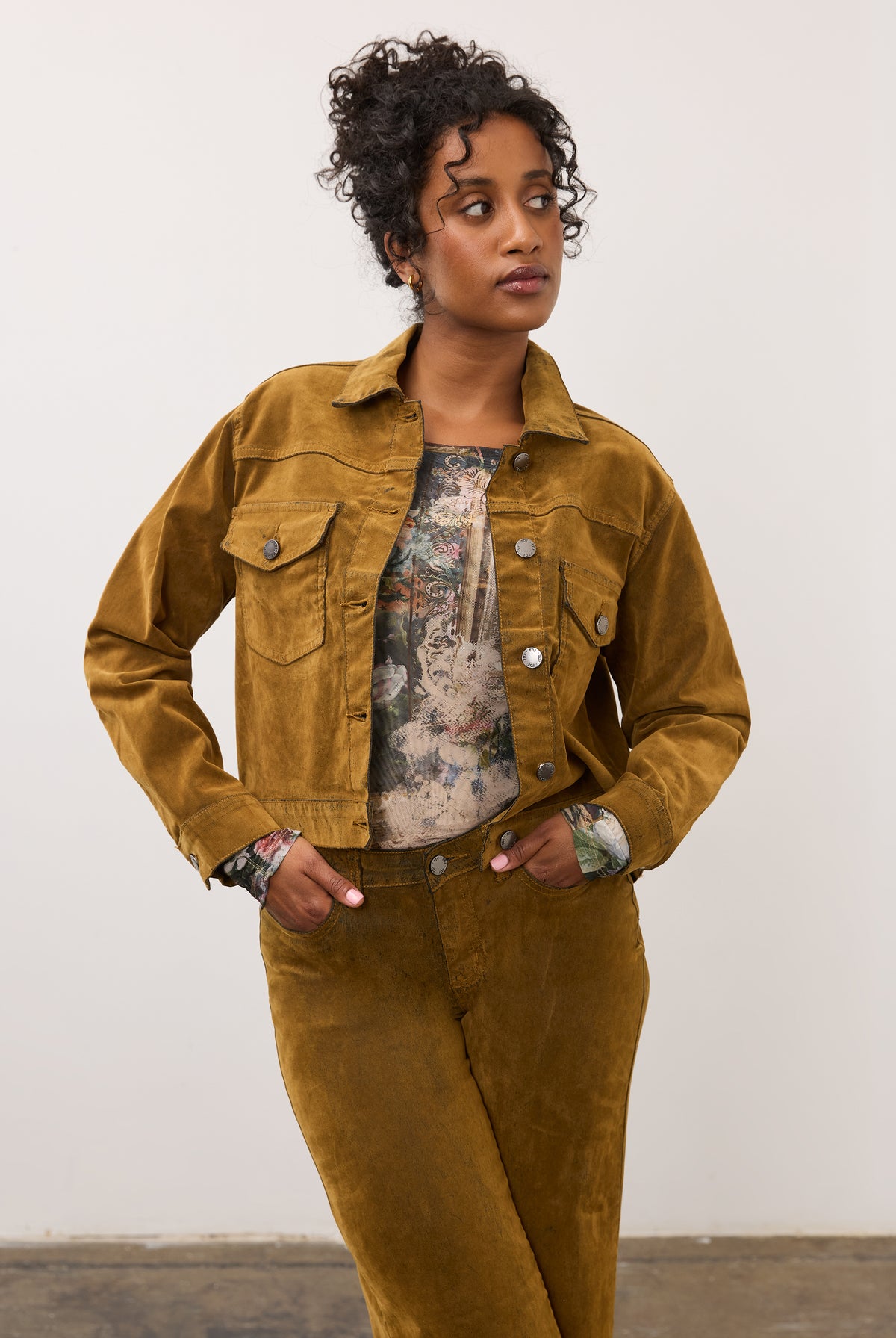 Close-up of model in brass Olivia denim and matching jacket, hands in pockets by French Dressing Jeans (FDJ)