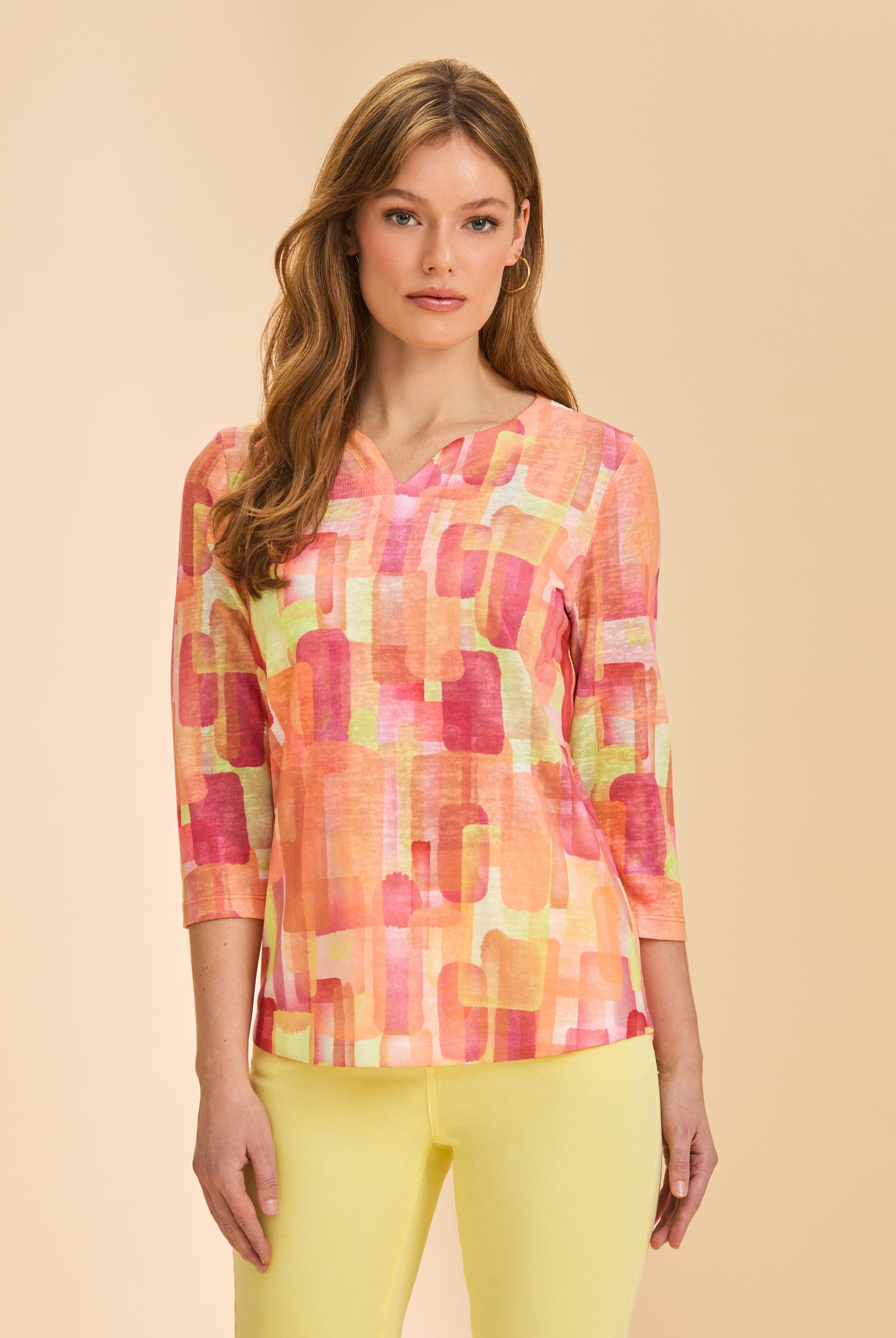 Front view of orange block print 3/4 sleeve V-neck top with yellow pants by French Dressing Jeans (FDJ)