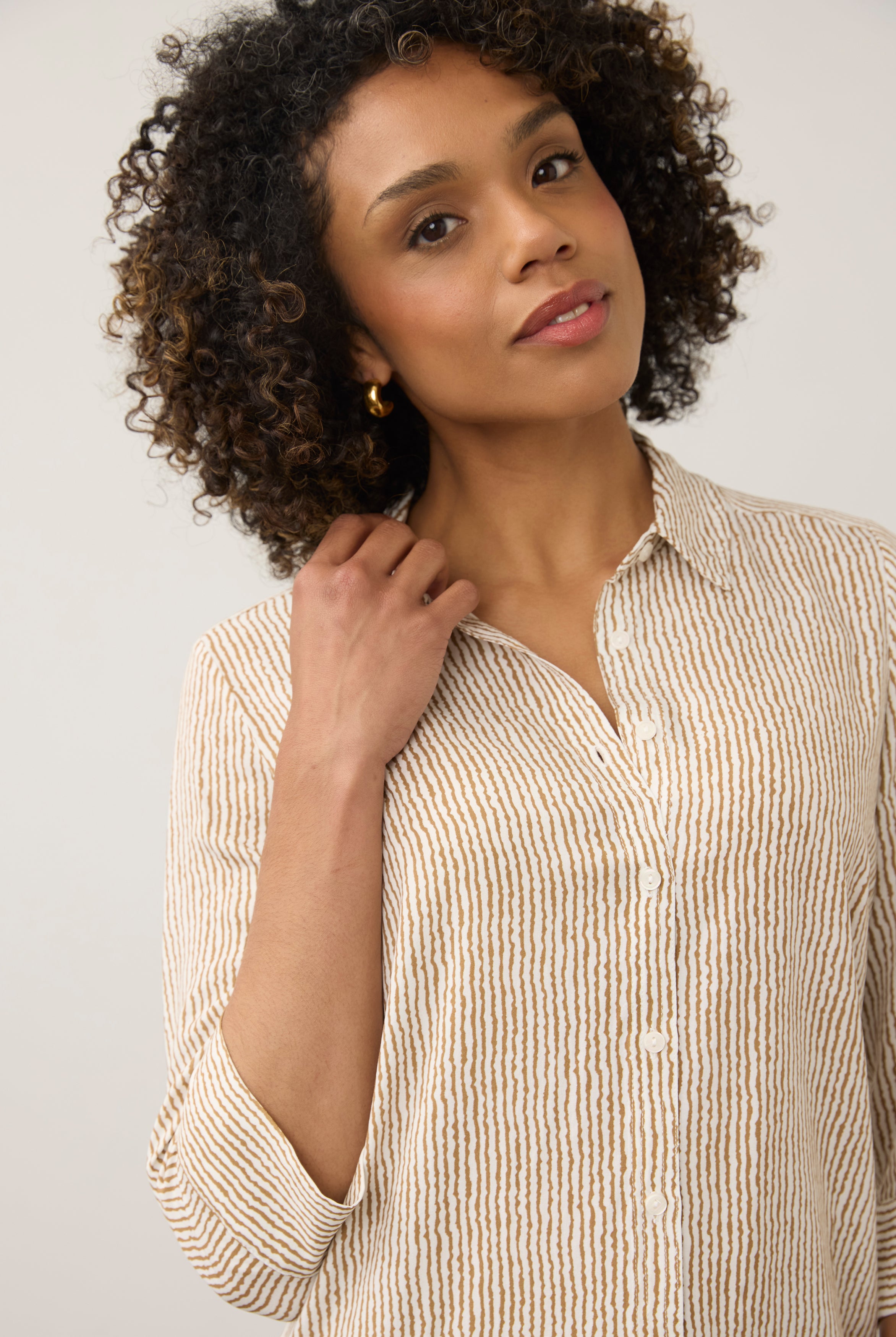 Close-up of striped beige and white shirt showing button details by French Dressing Jeans (FDJ)
