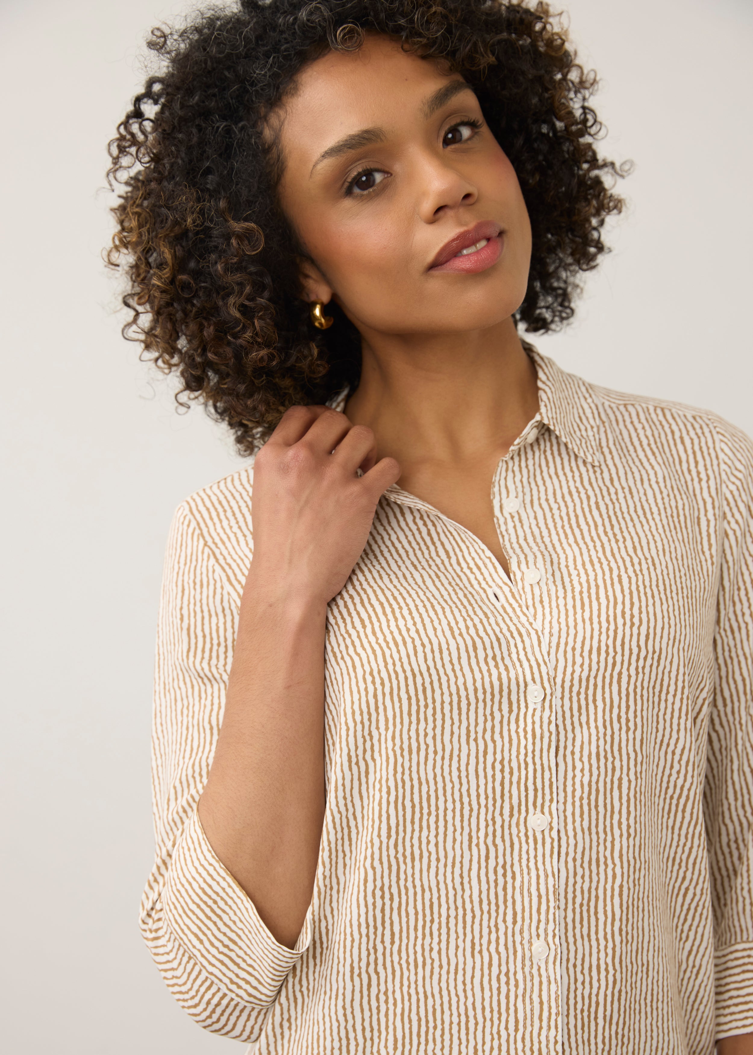 Close-up of striped beige and white shirt showing button details by French Dressing Jeans (FDJ)