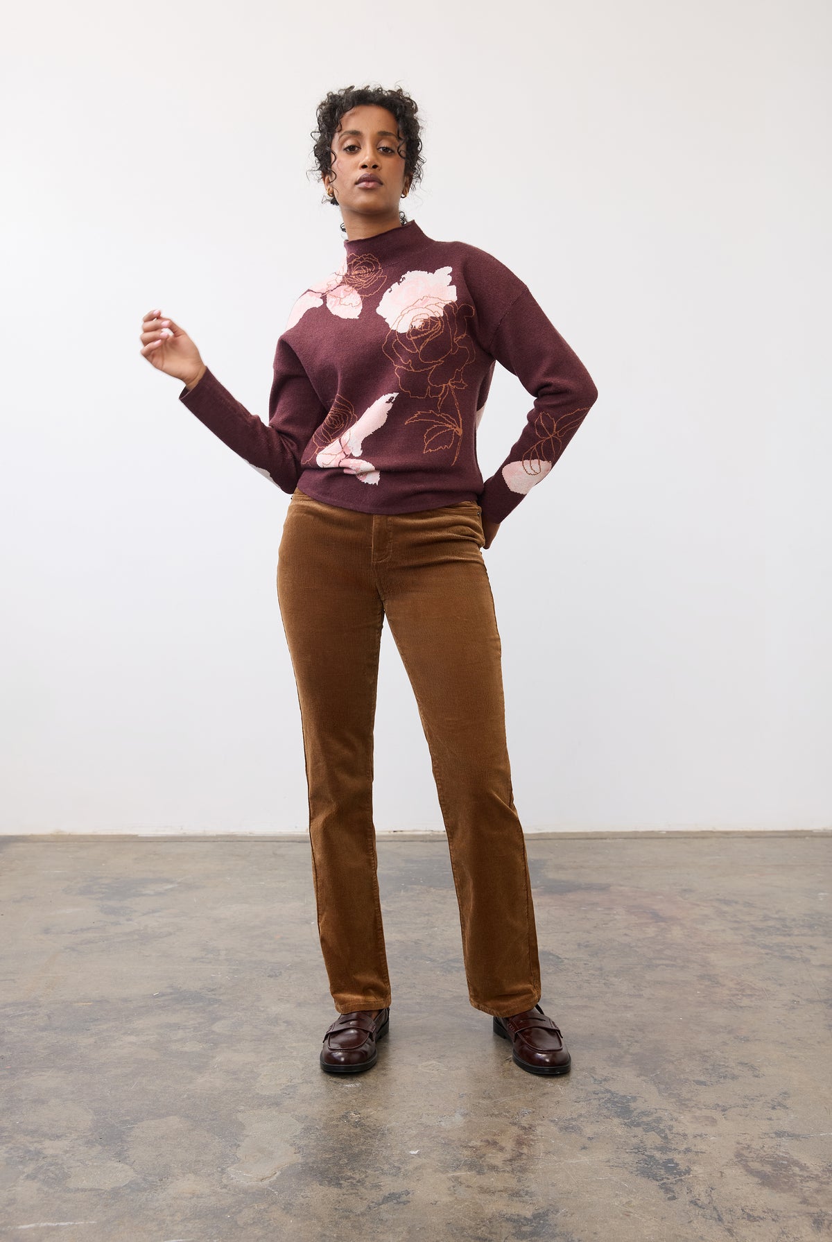 Full body view of burgundy floral sweater paired with brown corduroy pants by French Dressing Jeans (FDJ)