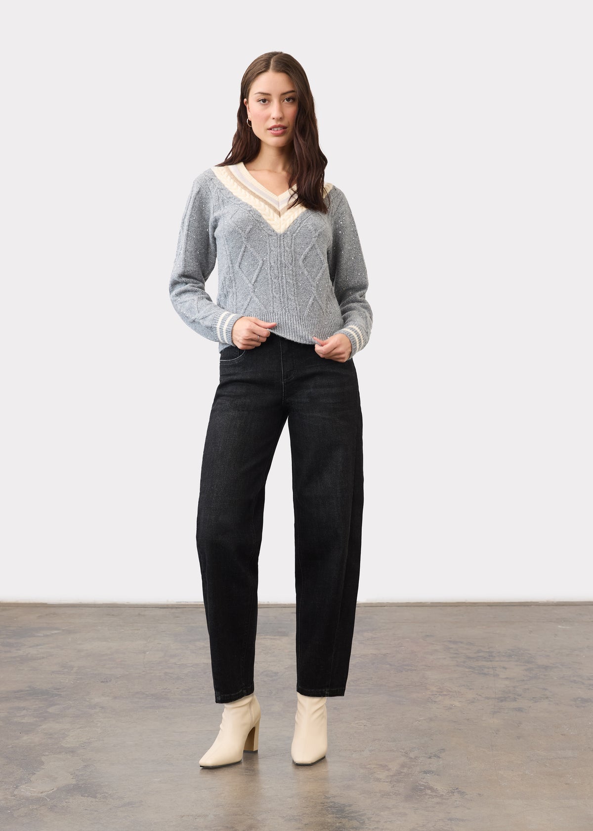 Full body view of black wide-leg jeans styled with a gray sweater by French Dressing Jeans (FDJ)