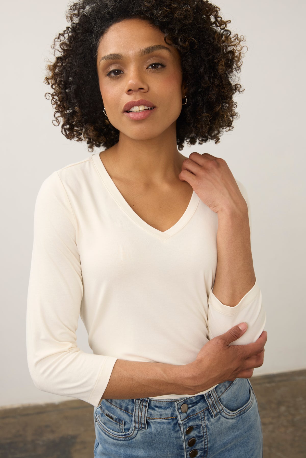 Close-up of cream V-neck top focusing on neckline and soft fabric texture by French Dressing Jeans (FDJ)