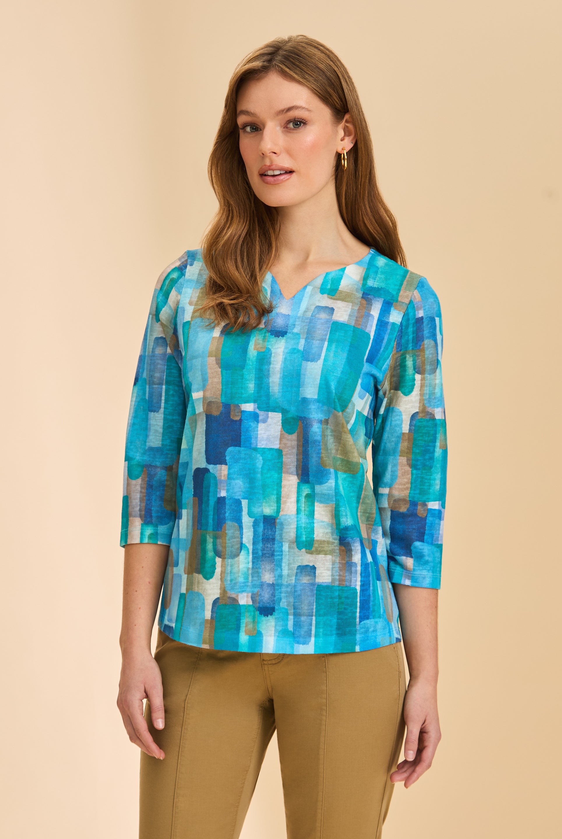 Front view of turquoise block print 3/4 sleeve V-neck top with tan pants by French Dressing Jeans (FDJ)