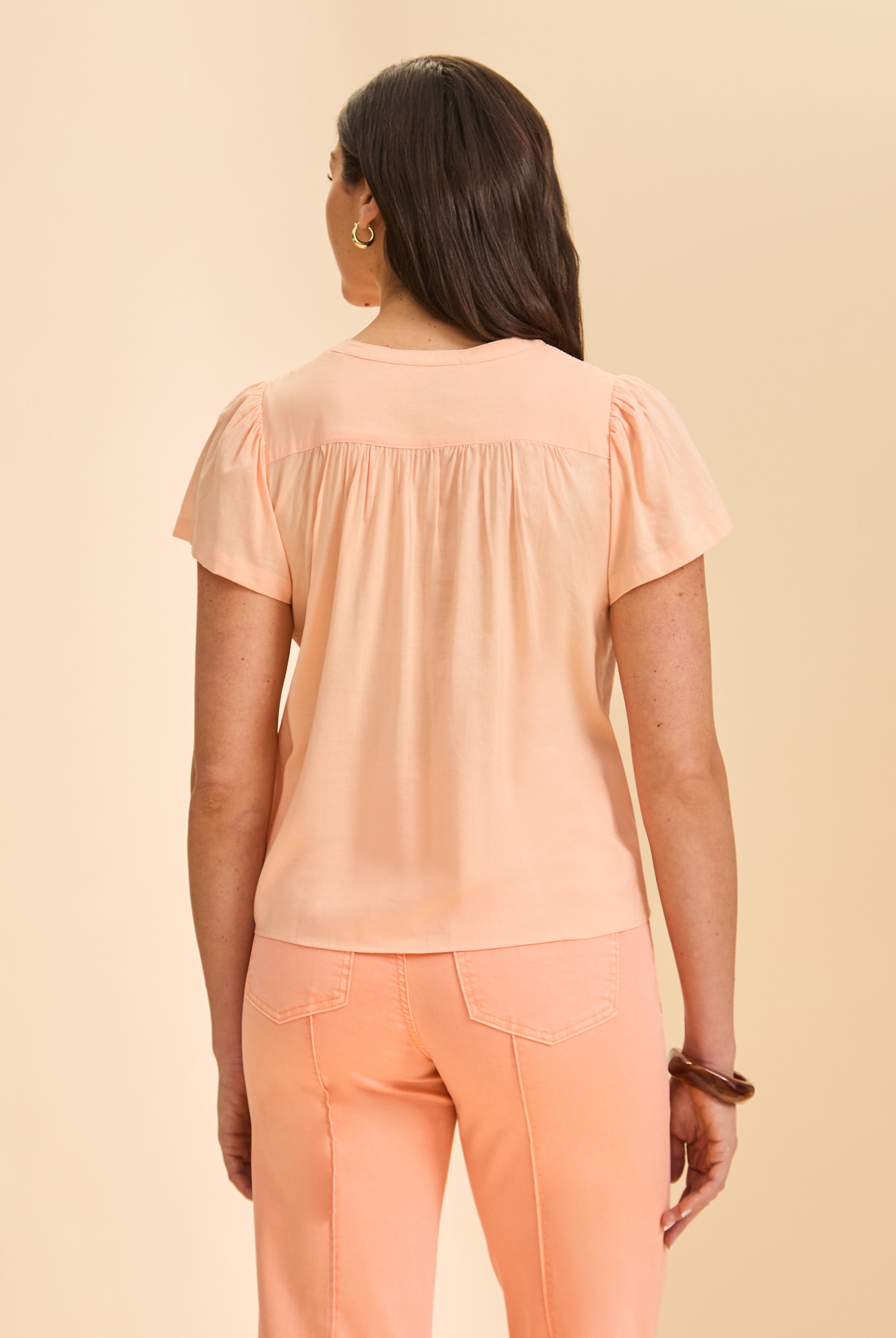 Back view of peach short-sleeve top showcasing yoke detail by French Dressing Jeans (FDJ)