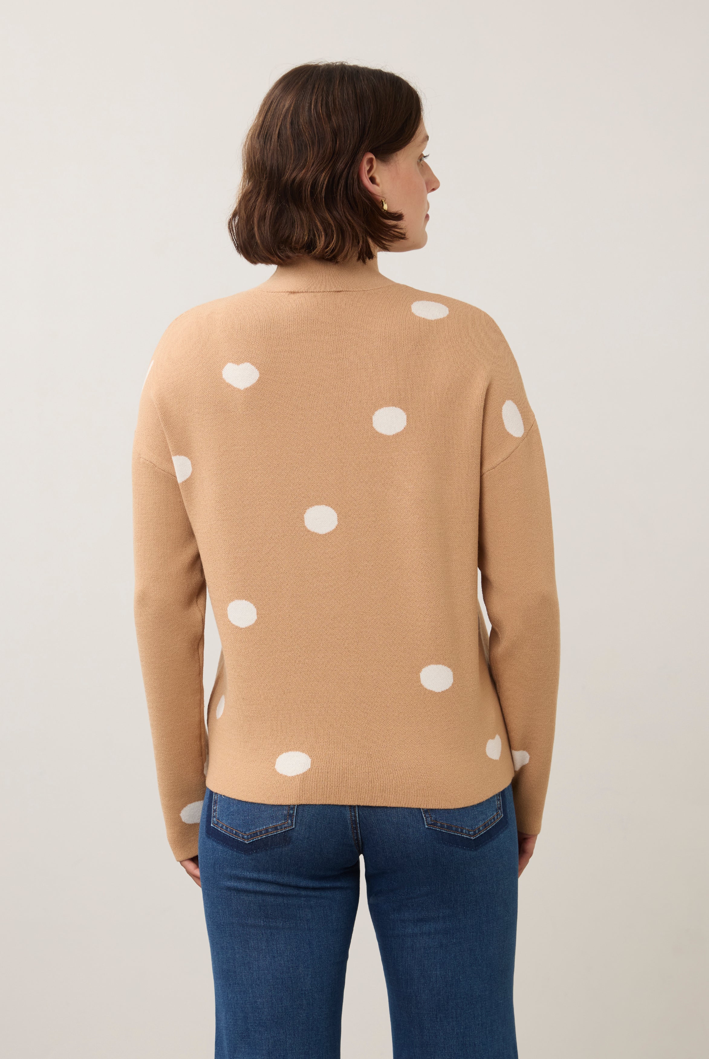 Back view of tan polka dot sweater showing seamless design by French Dressing Jeans (FDJ)