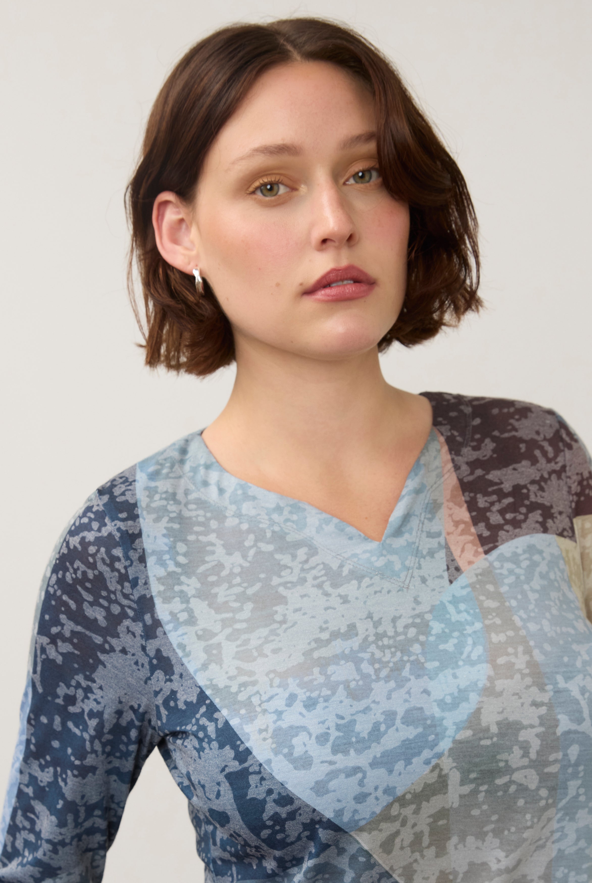Close-up of notch neckline detail on 3/4 sleeve top in multi-color Warn pattern by French Dressing Jeans (FDJ)