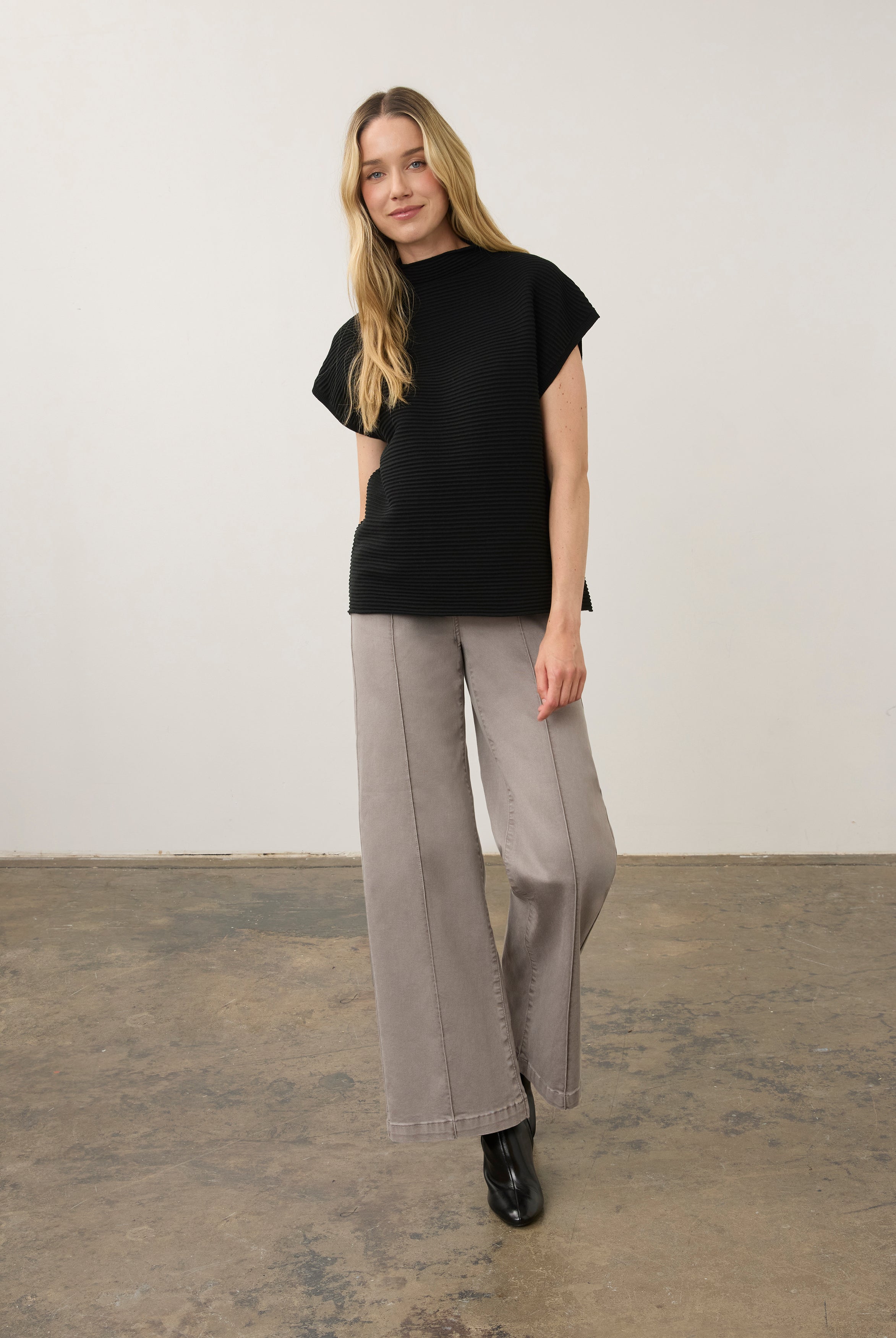 Model in black ribbed top paired with wide-leg pants, full outfit view by French Dressing Jeans (FDJ)