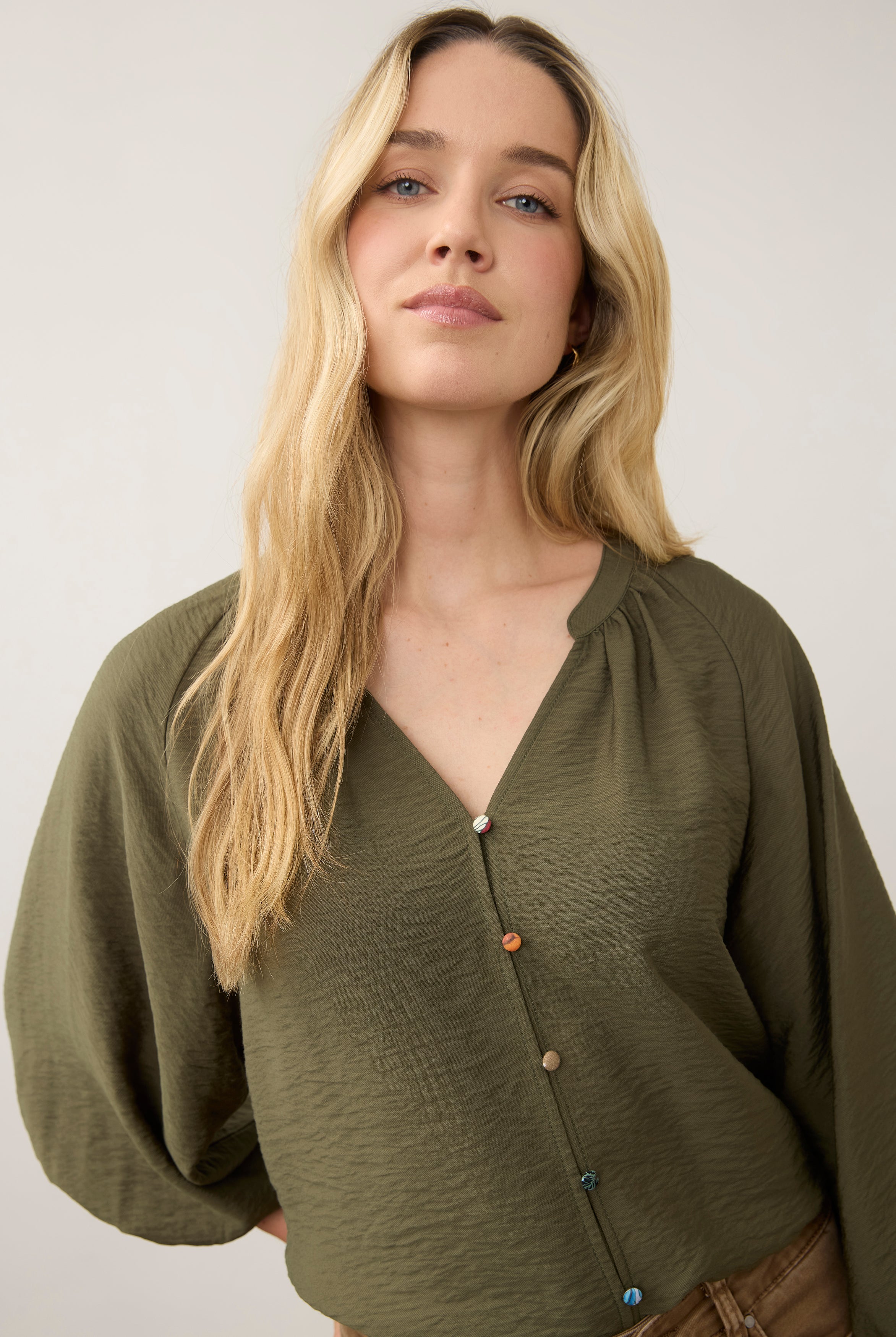 Close-up of olive blouse showing colorful buttons by French Dressing Jeans (FDJ)