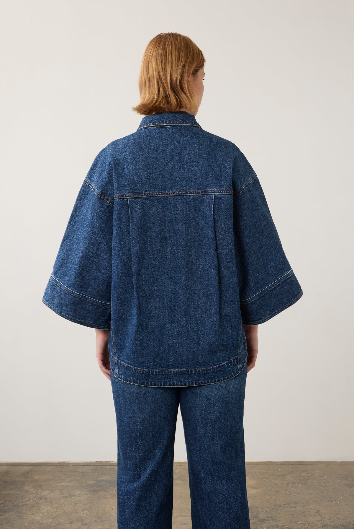 Back view of oversized medium blue utility jacket showing elegant drape by French Dressing Jeans (FDJ) par French Dressing Jeans (FDJ)