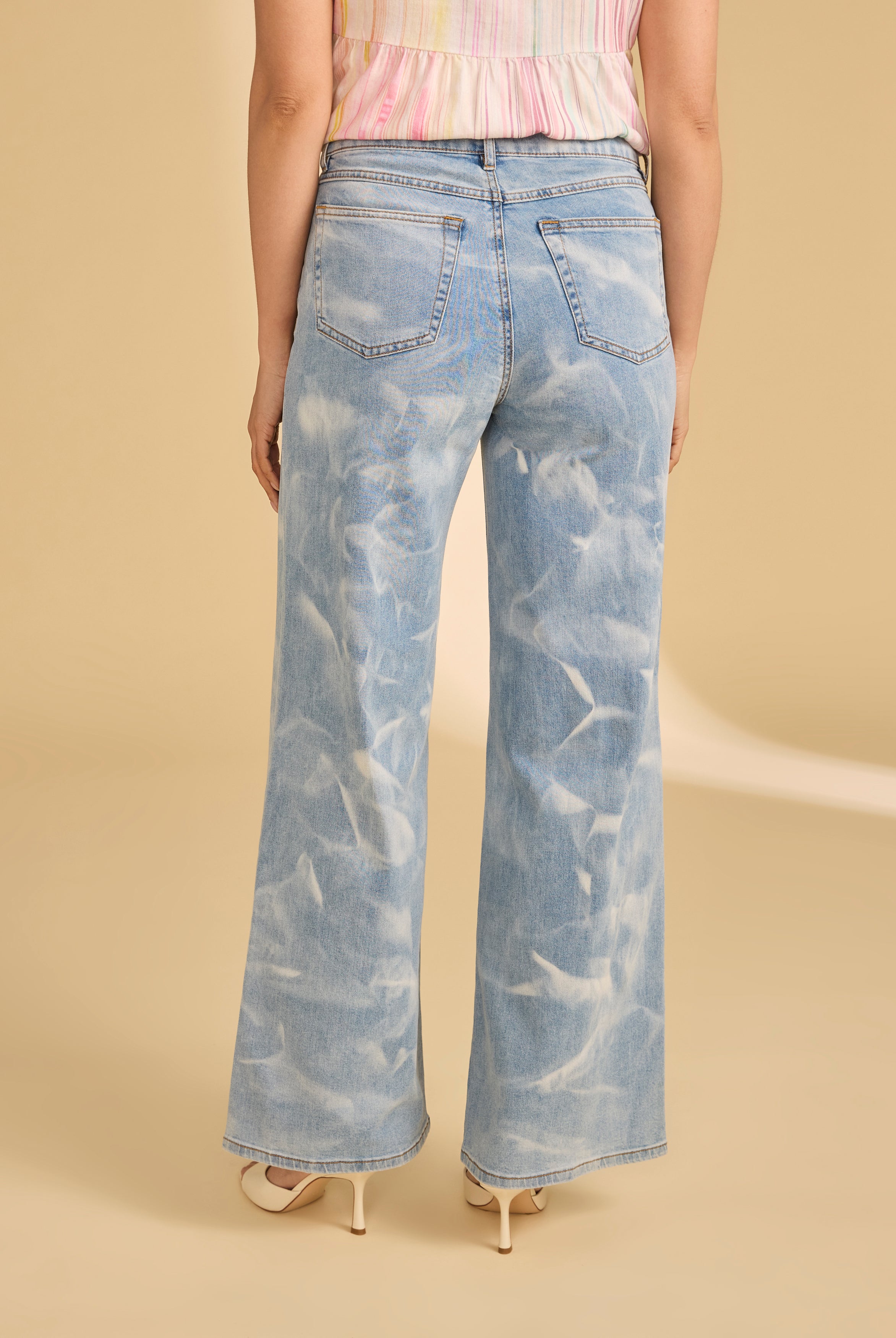 Back view of light denim jeans showing patch pockets and faded wash by French Dressing Jeans (FDJ)