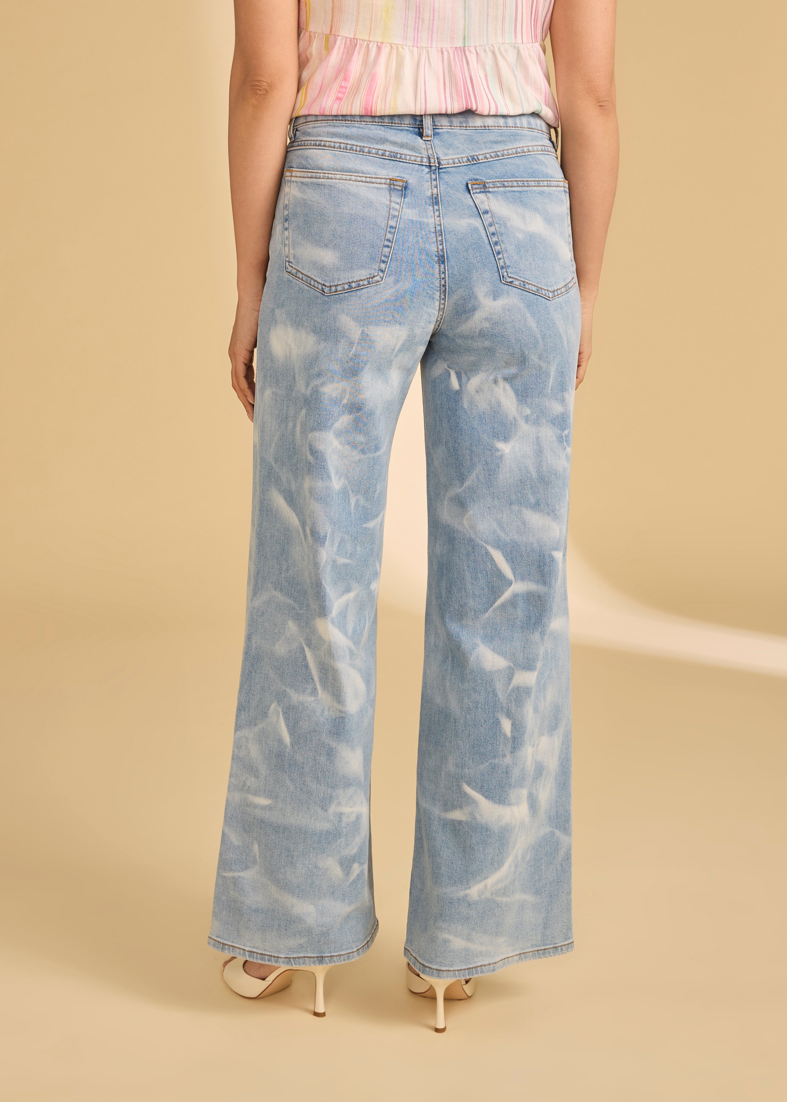 Back view of light denim jeans showing patch pockets and faded wash by French Dressing Jeans (FDJ)