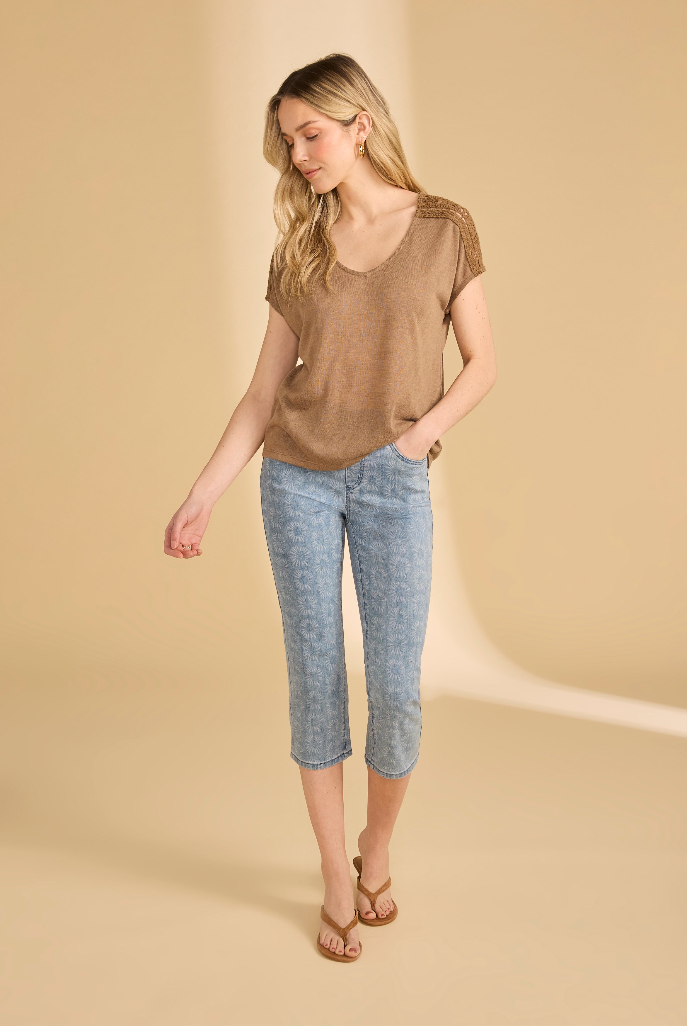 Full view of brown V-neck top paired with flower-patterned jeans by French Dressing Jeans (FDJ)