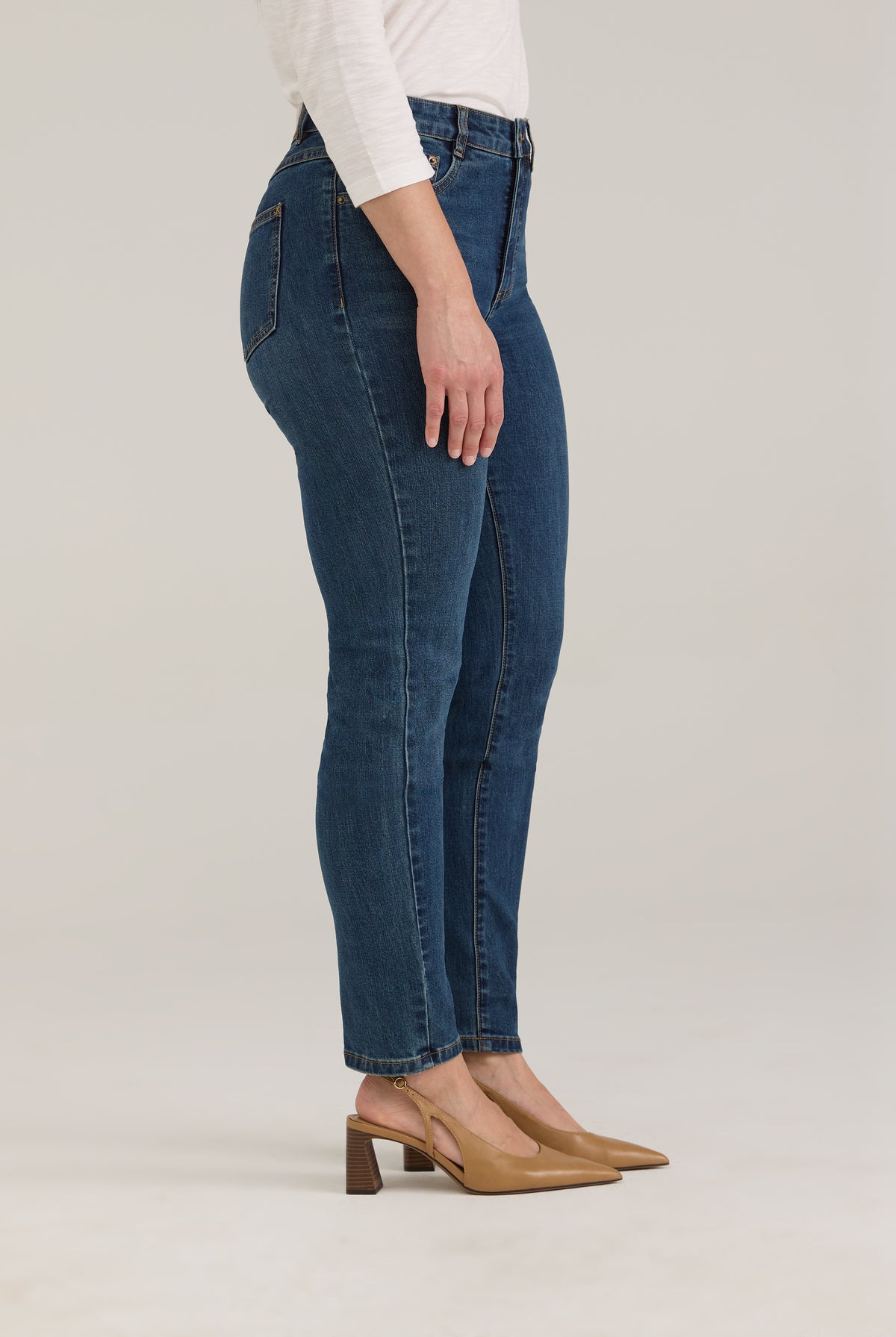 Side profile of dark wash slim leg jeans highlighting the silhouette by French Dressing Jeans (FDJ)